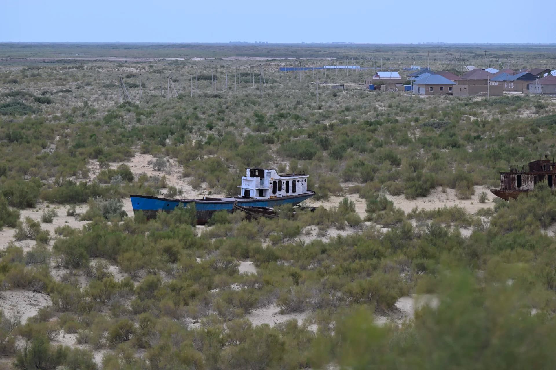 Abandoned ship in a dry landscape with vegetation