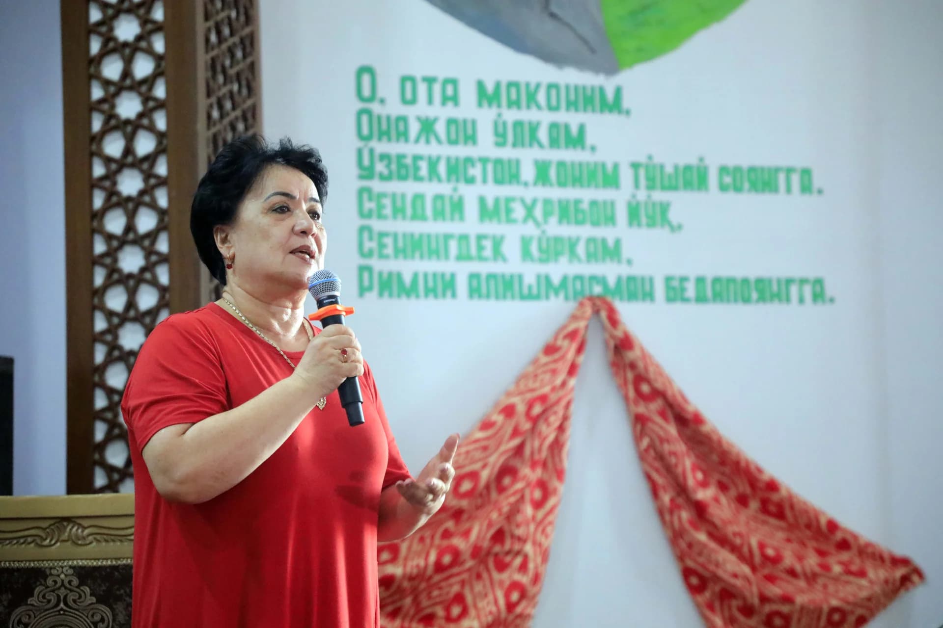 Woman speaking into a microphone indoors