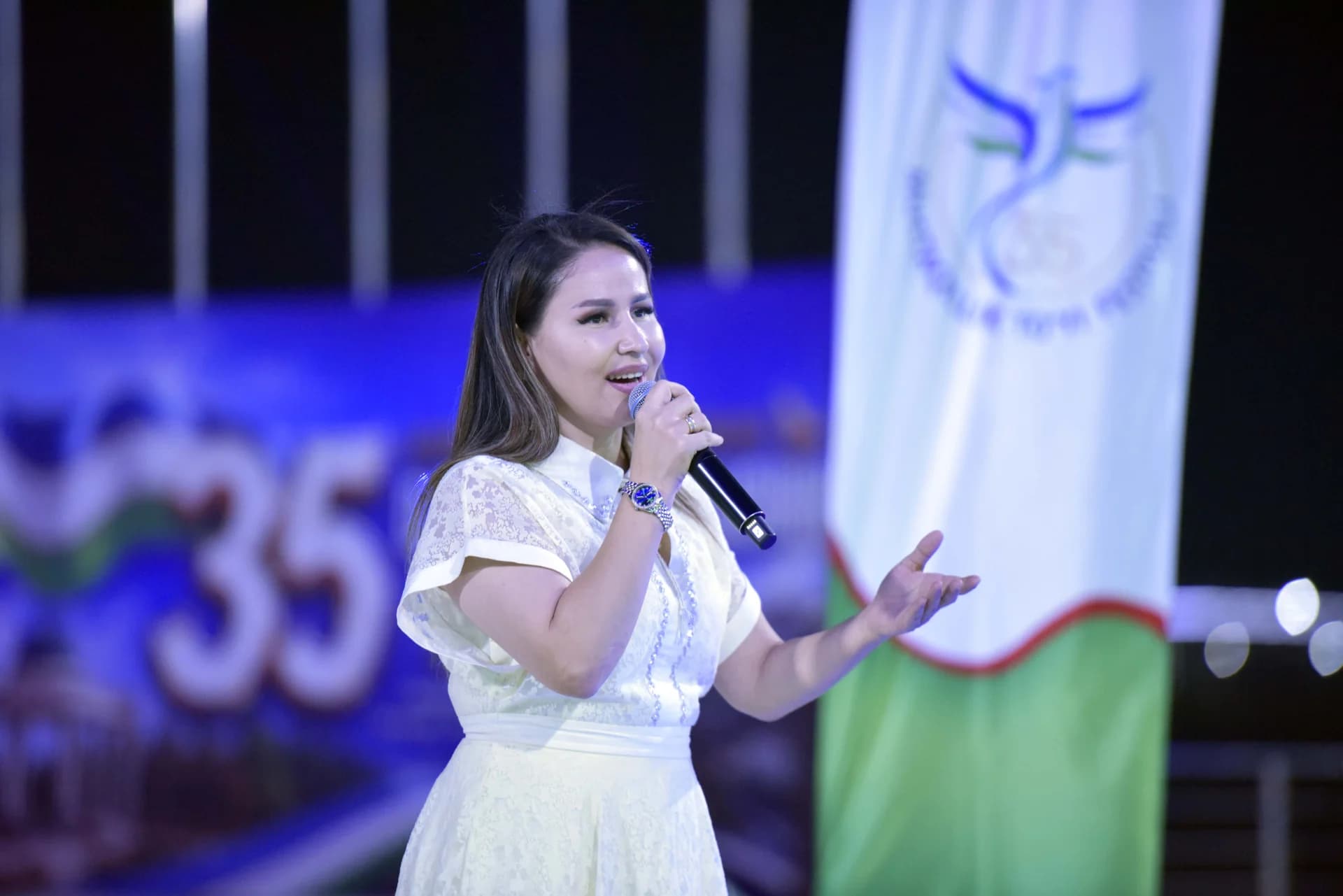 Woman singing into microphone on stage