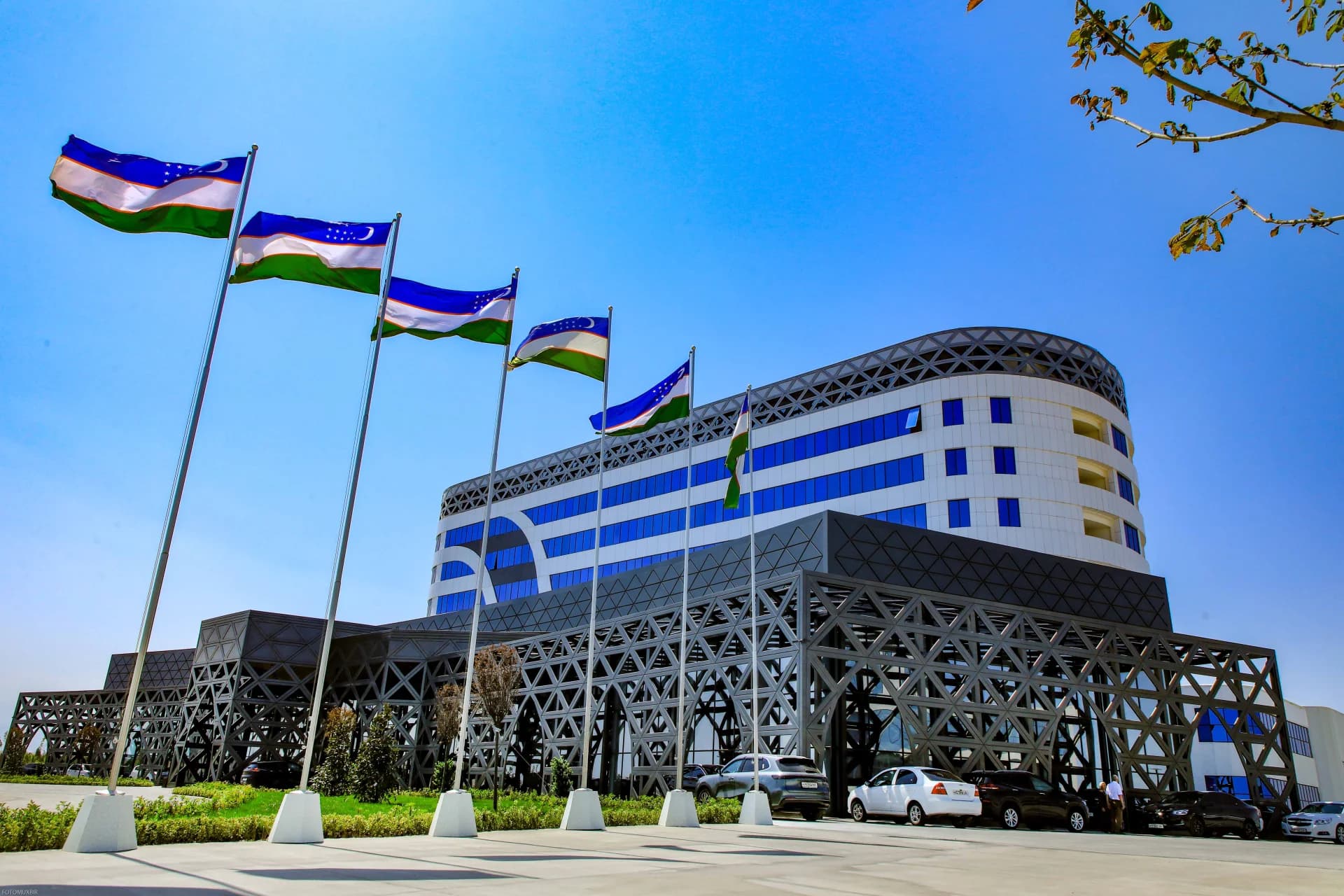 National flags flying before a modern building