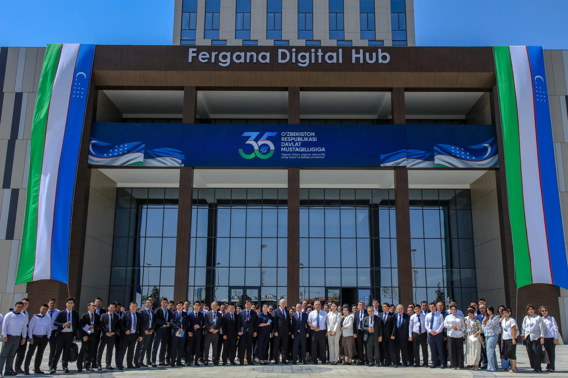 Group of people standing outside Fergana Digital Hub building