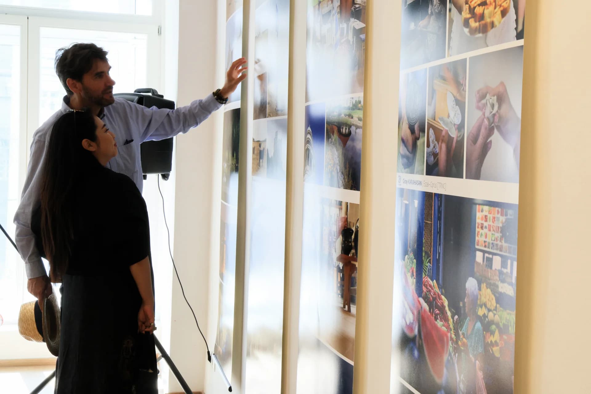 People looking at photo exhibits on display walls