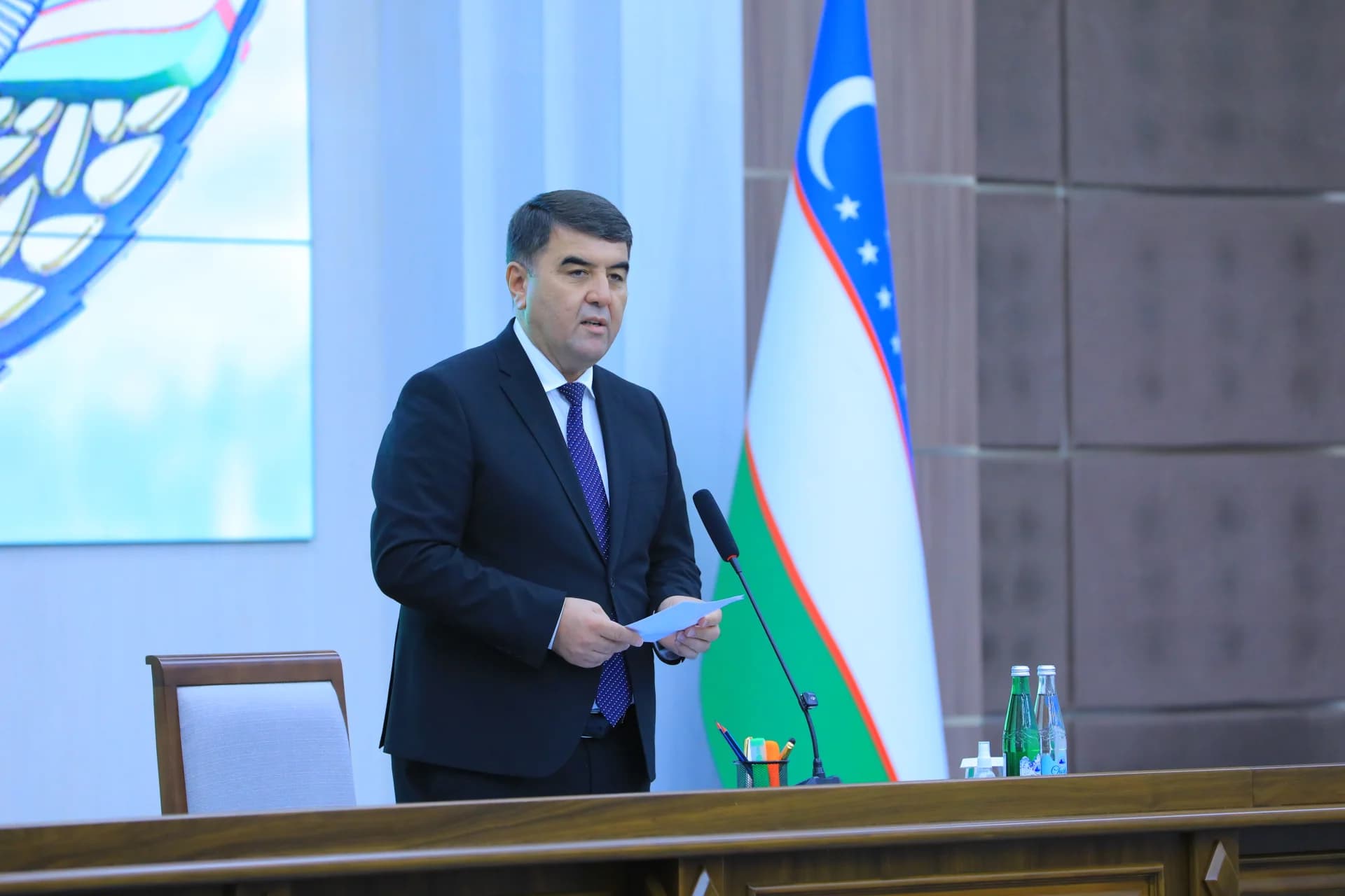 Мужчина, выступающий на конференционной трибуне