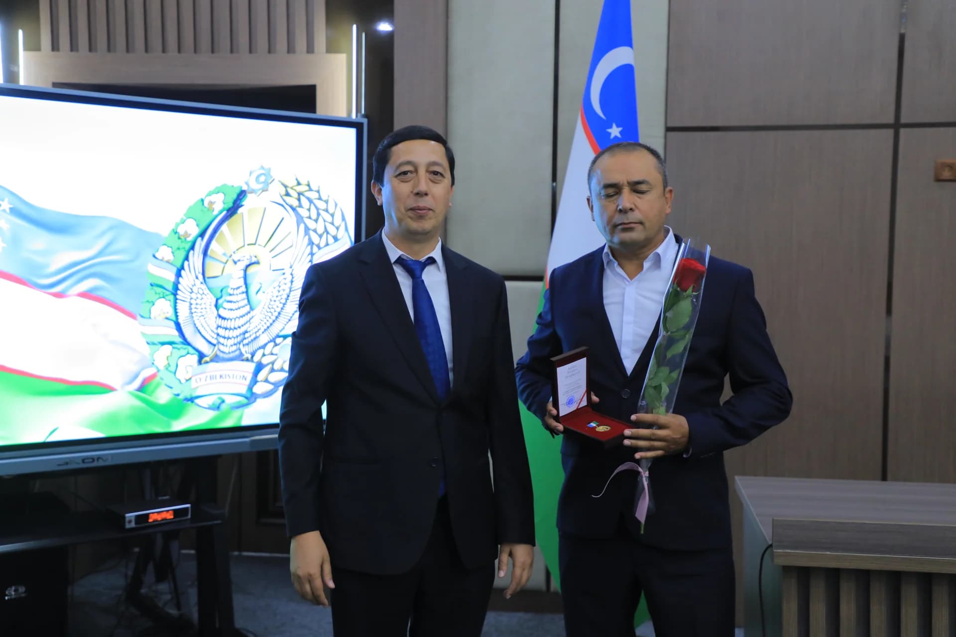 Two men posing together indoors