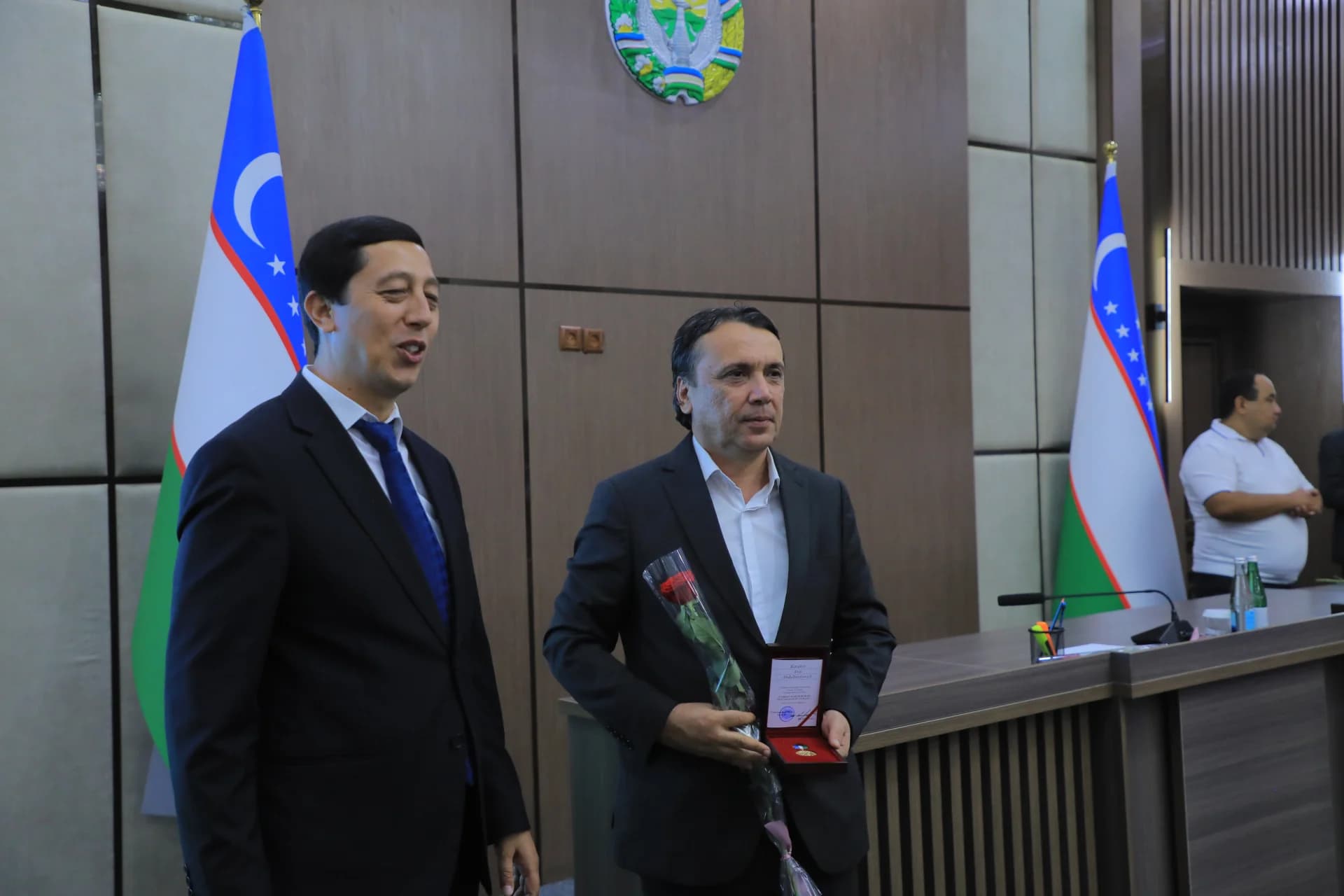 Men standing indoors with flags