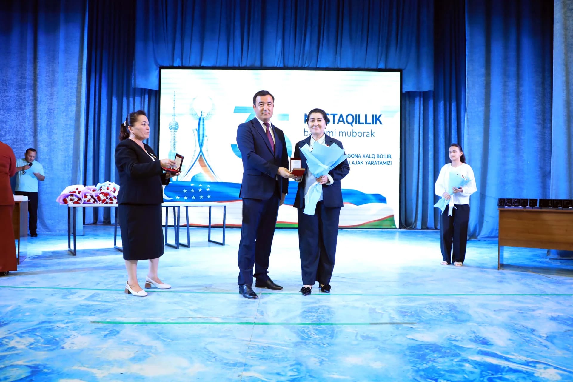 People participating in an award ceremony on a stage