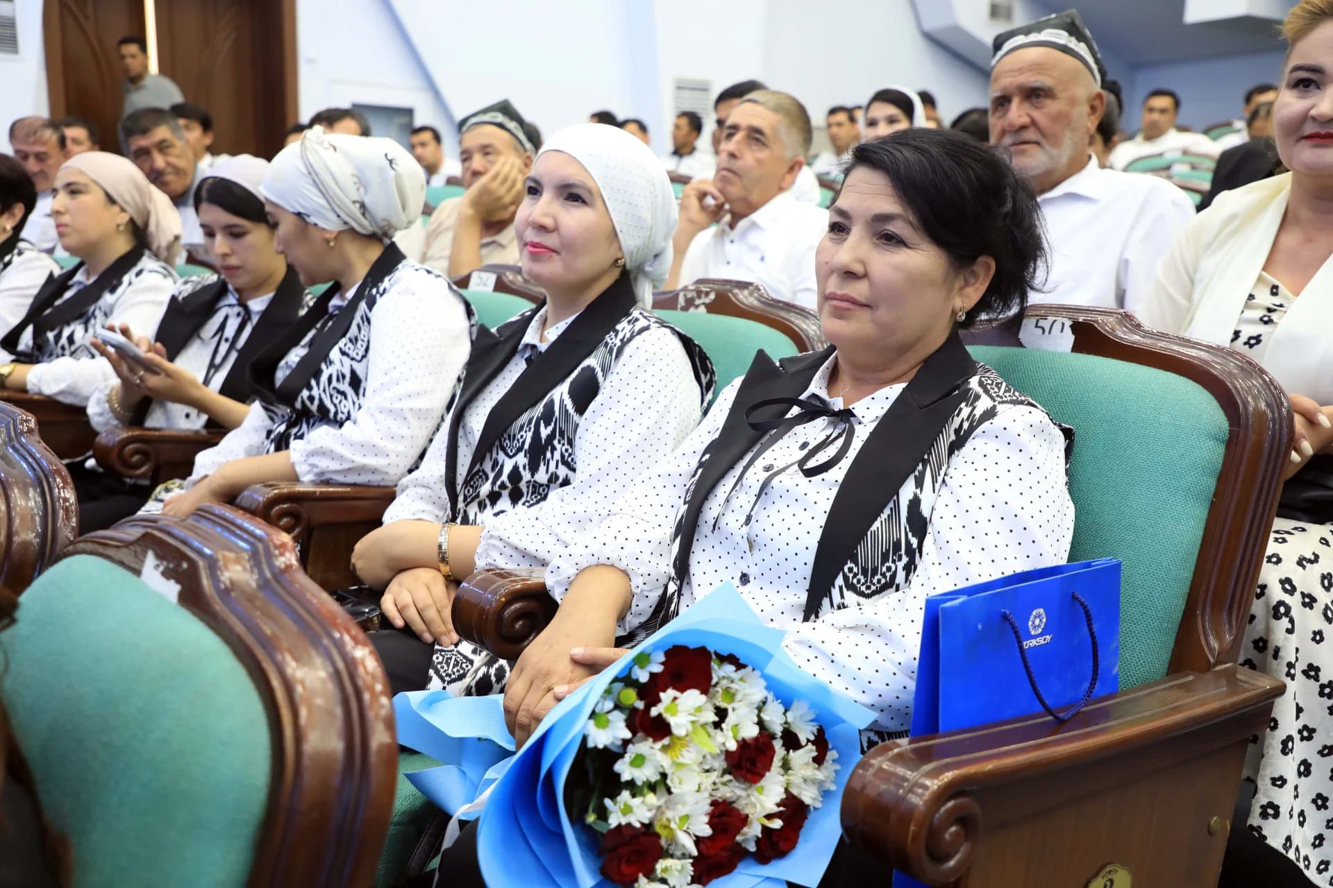People seated in an audience indoors