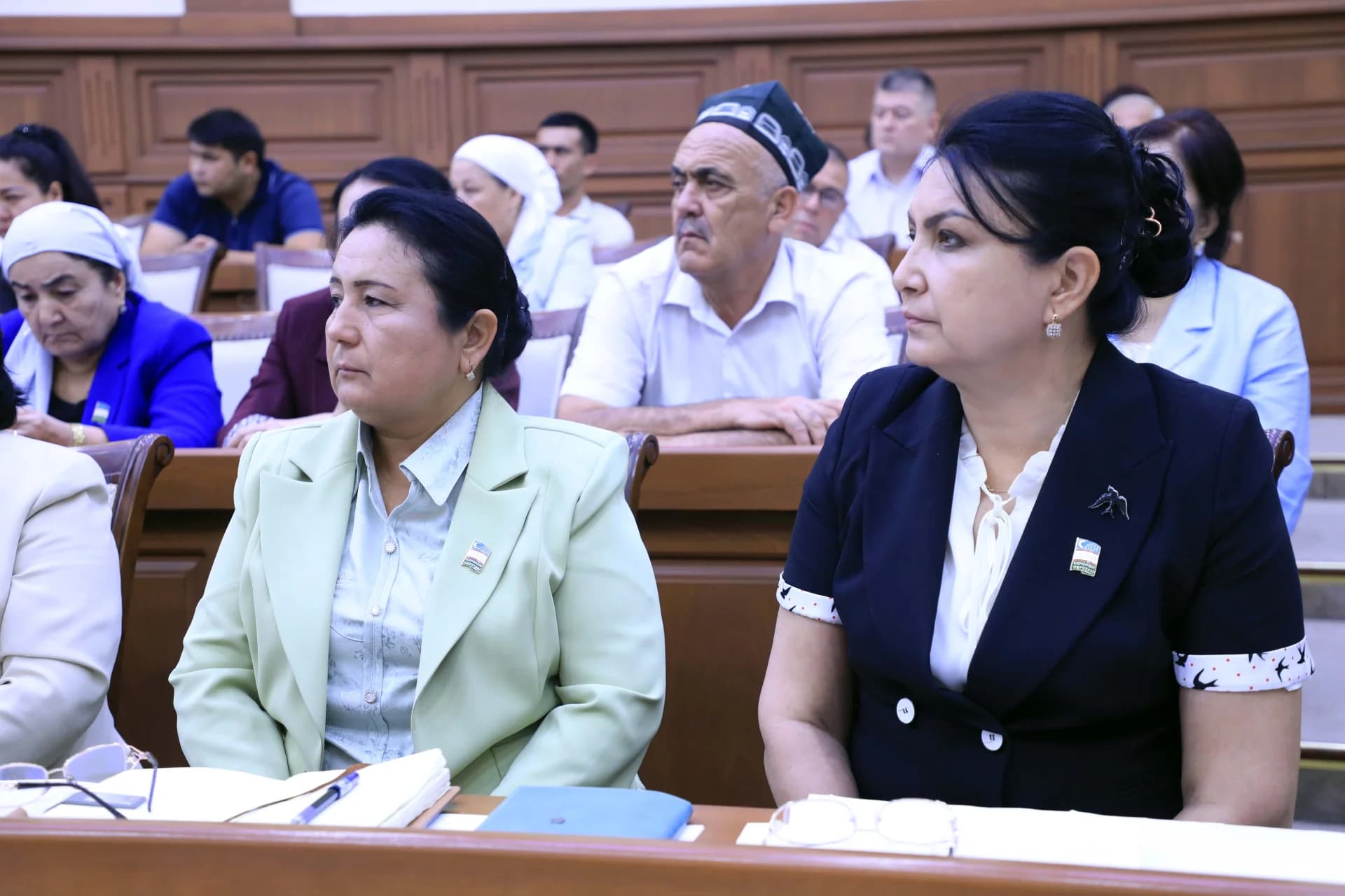 People seated in an audience during a meeting