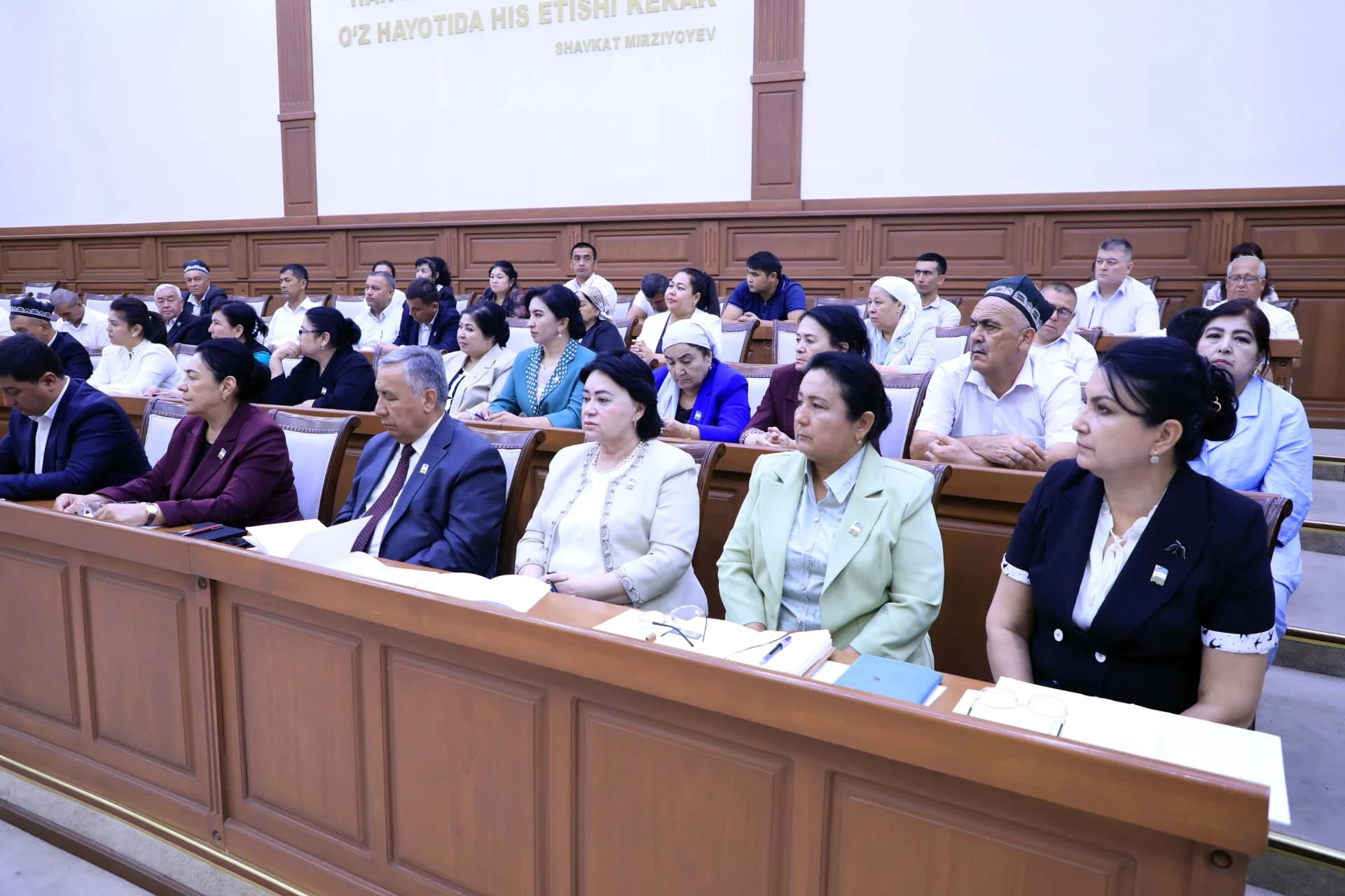People seated in a conference hall