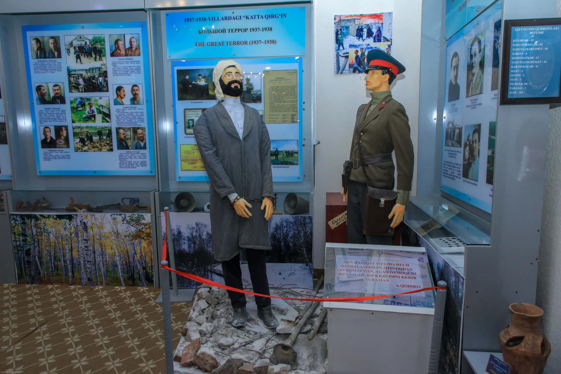 Museum display featuring mannequins representing historical figures with informational panels