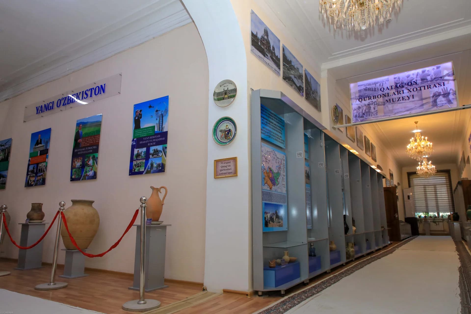 Interior view of a museum exhibition hall with display cases and wall panels