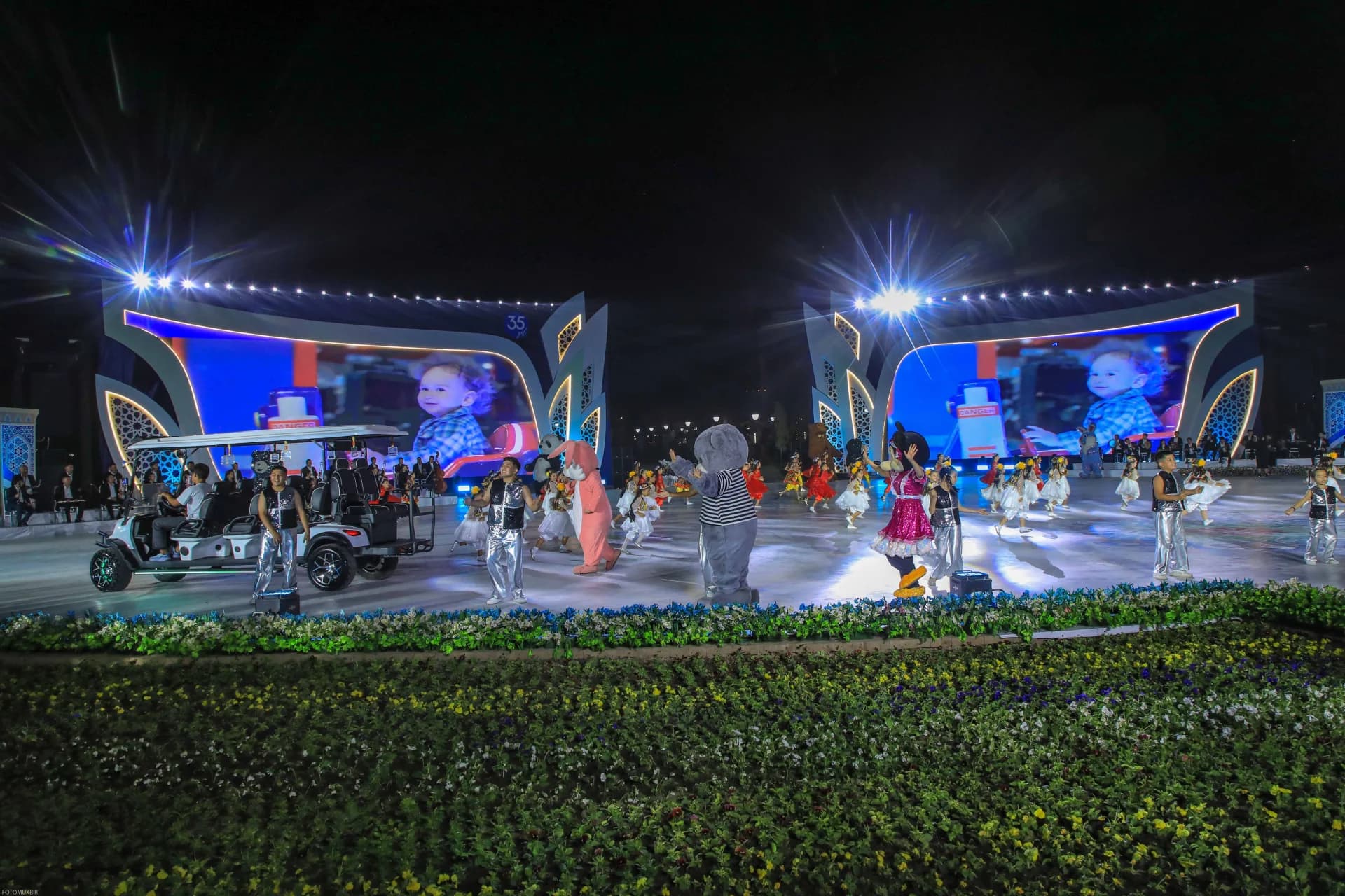 Performers and costumed characters on stage