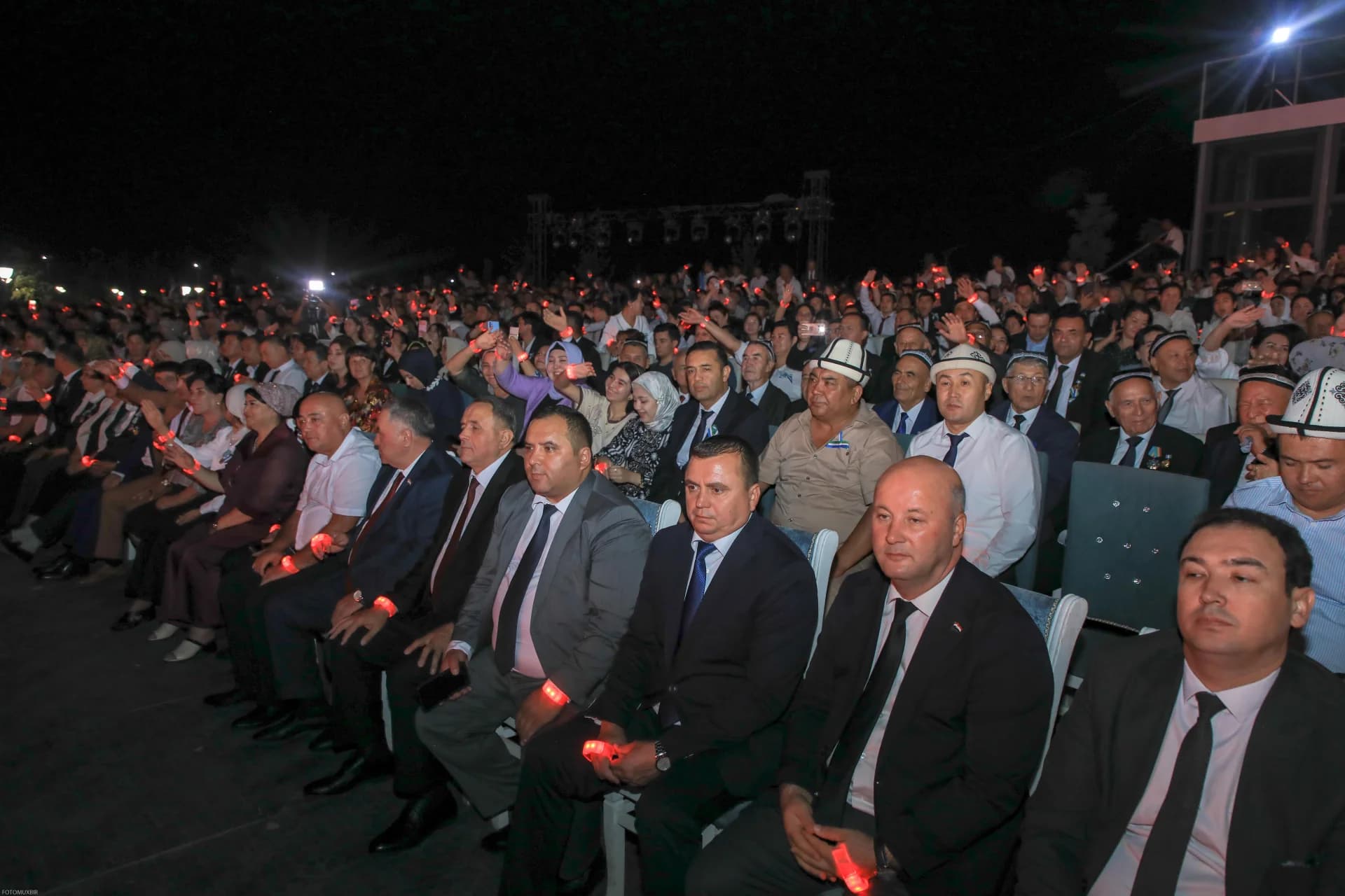 Crowd gathered at a night event outdoors