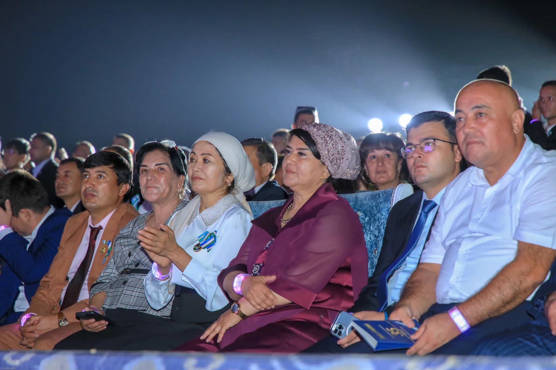 People seated in an audience at an event
