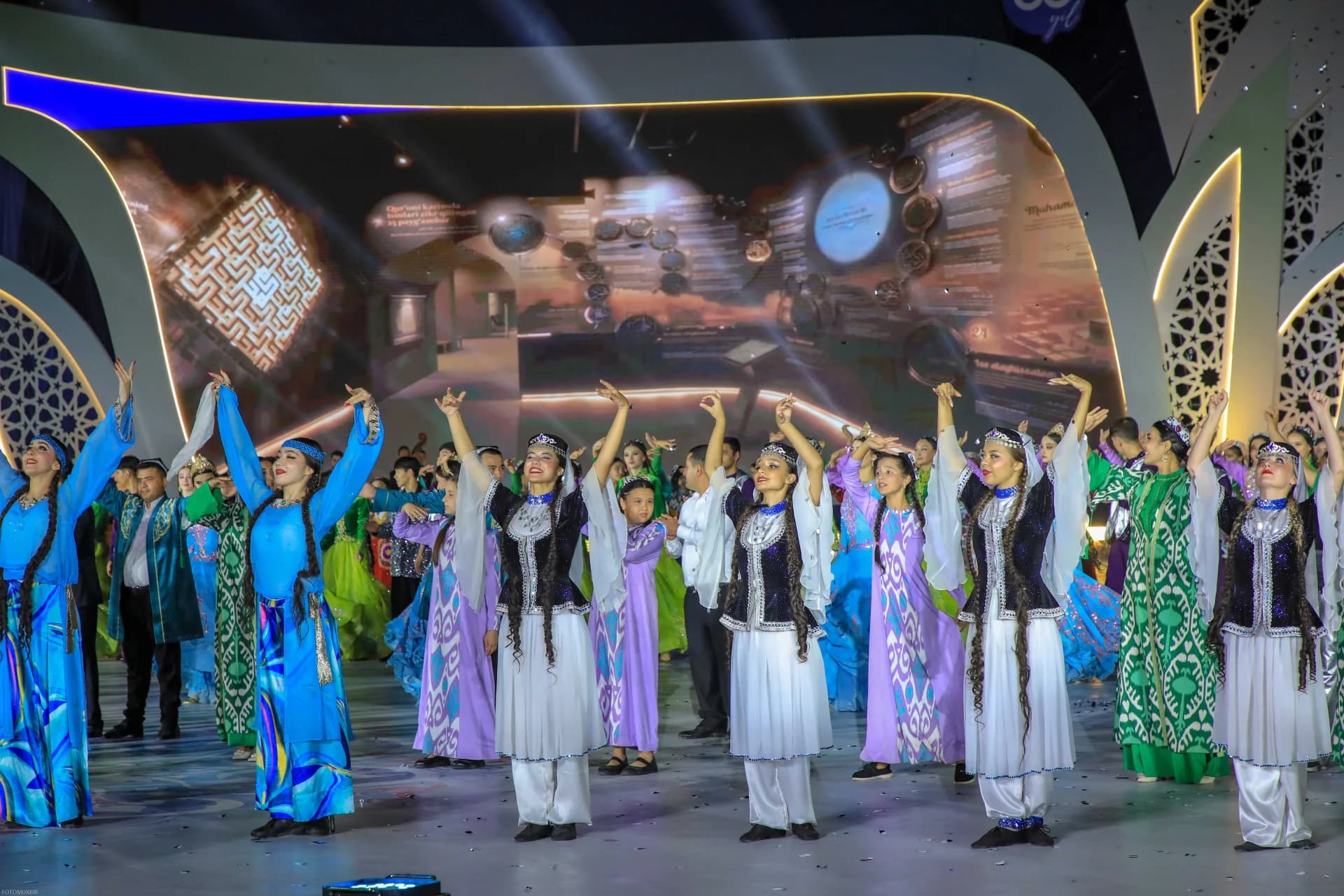Performers in traditional attire dancing on stage