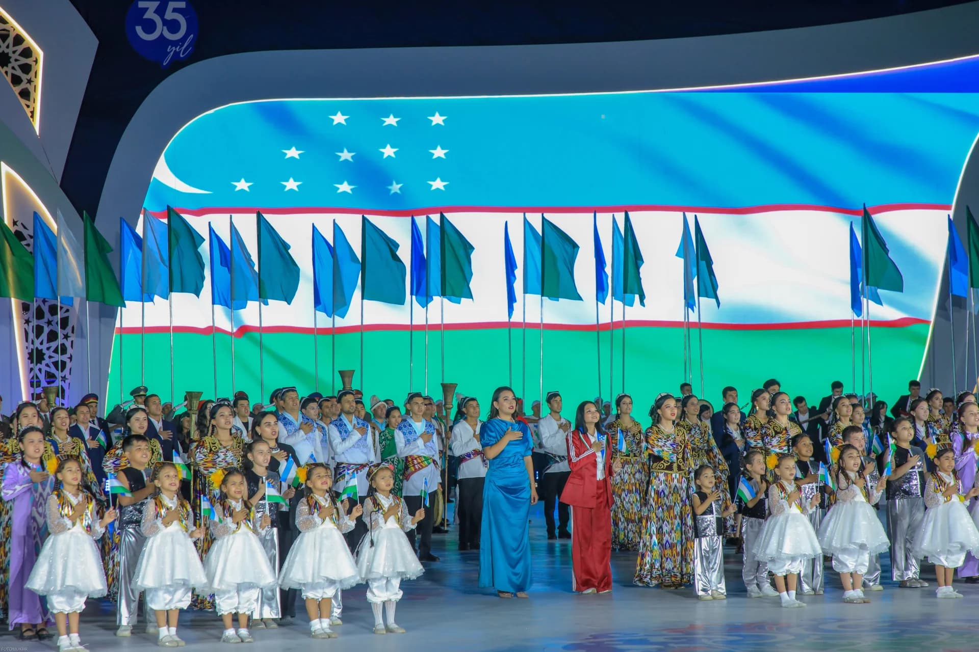 People gathered on stage with flags