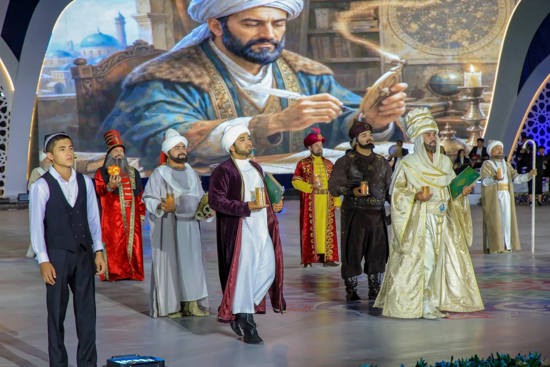 People in traditional clothing on stage during a performance