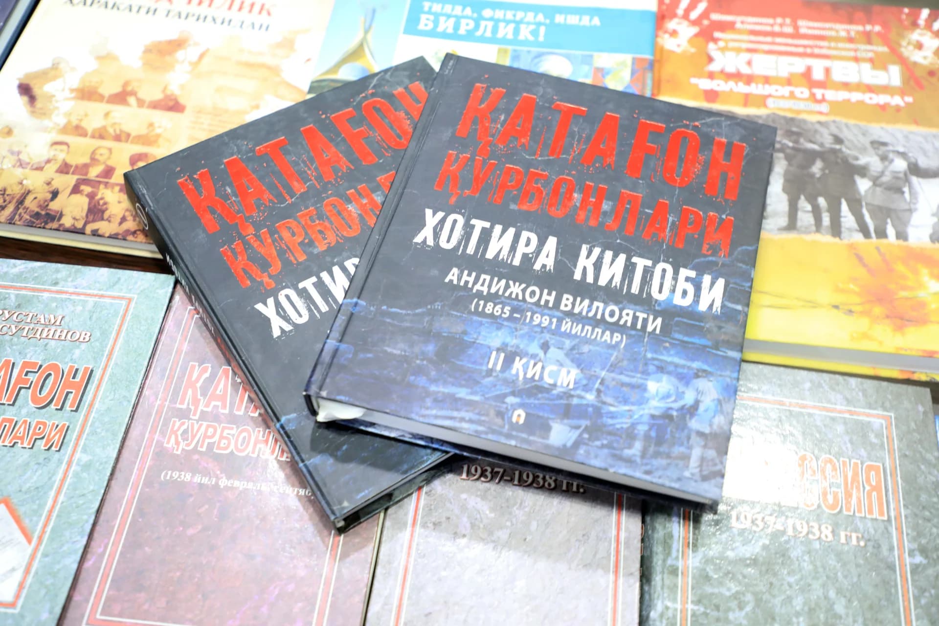 Several books with visible text on their covers are arranged on a surface