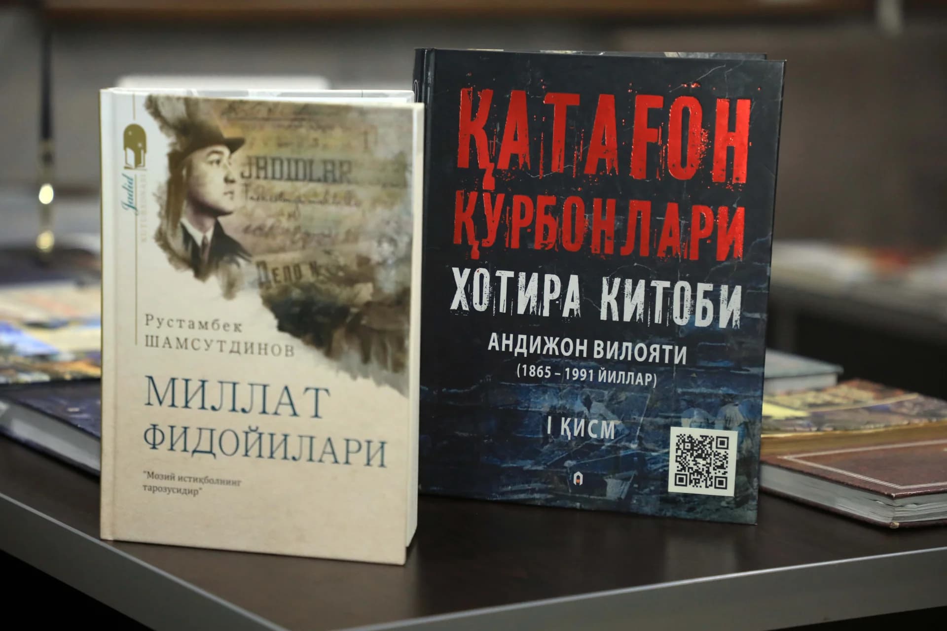 Books with visible titles and text displayed on a table