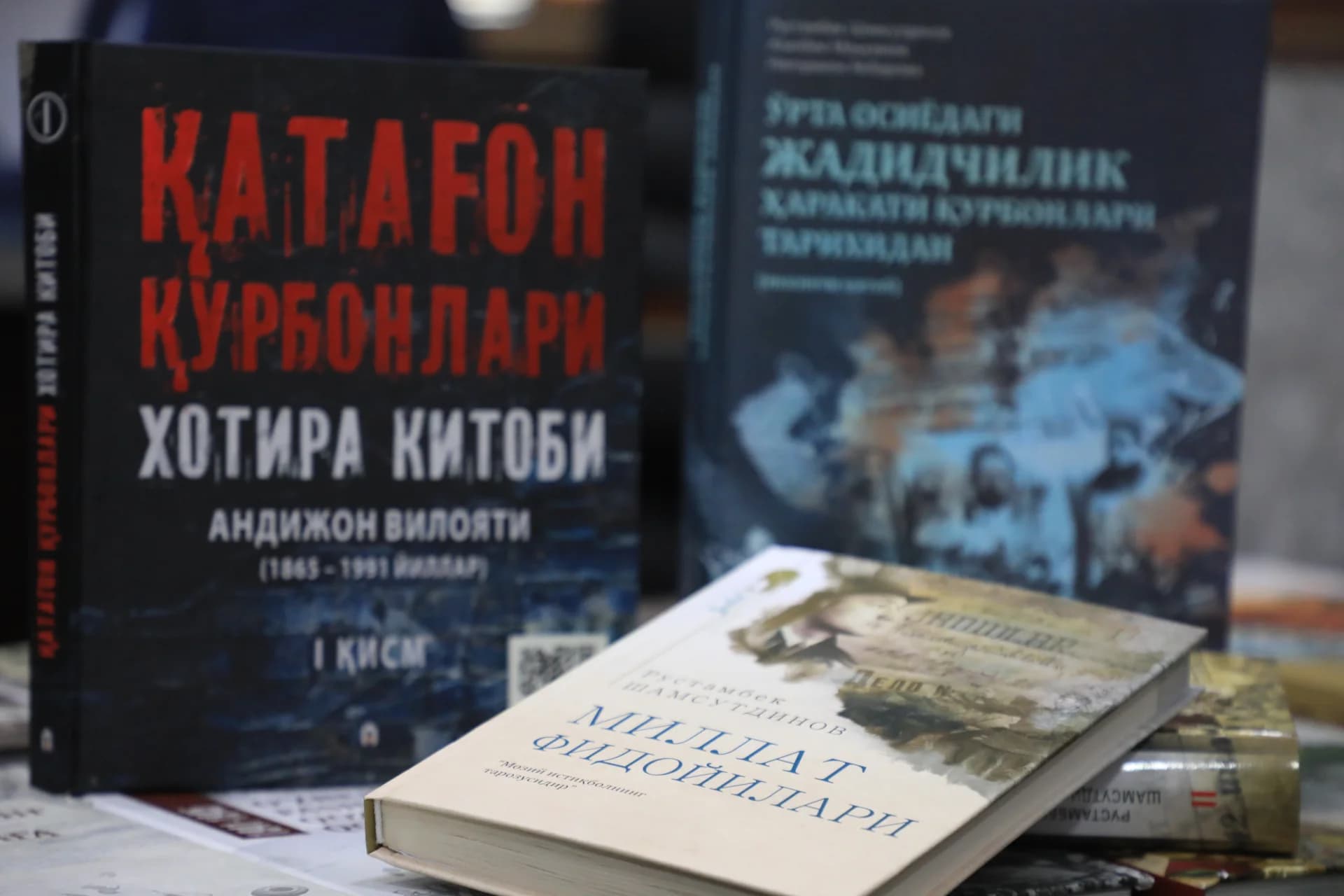 Several books with visible text on covers arranged on a surface