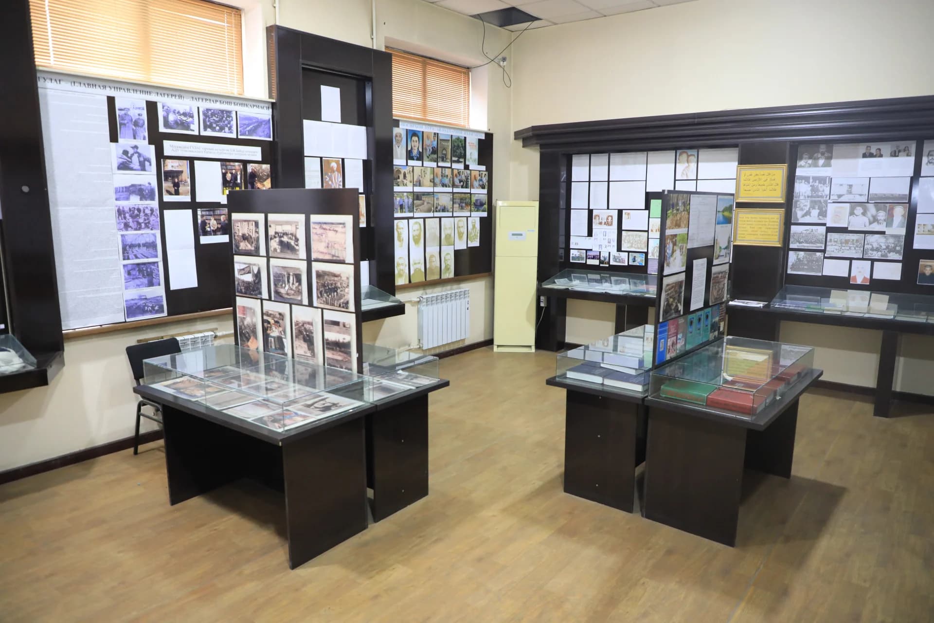 Interior view of an exhibition room with display cases and wall exhibits