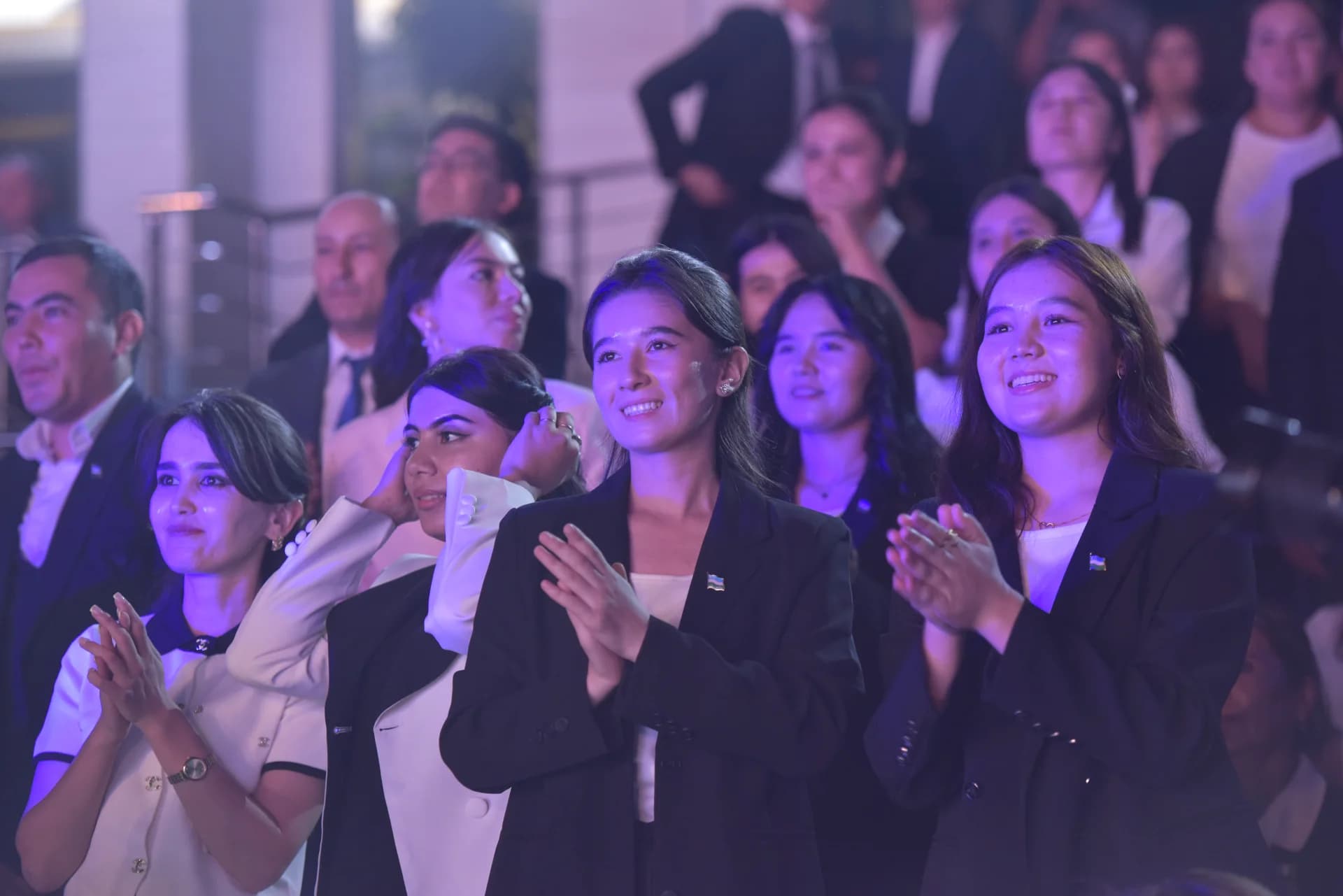 People clapping in an audience