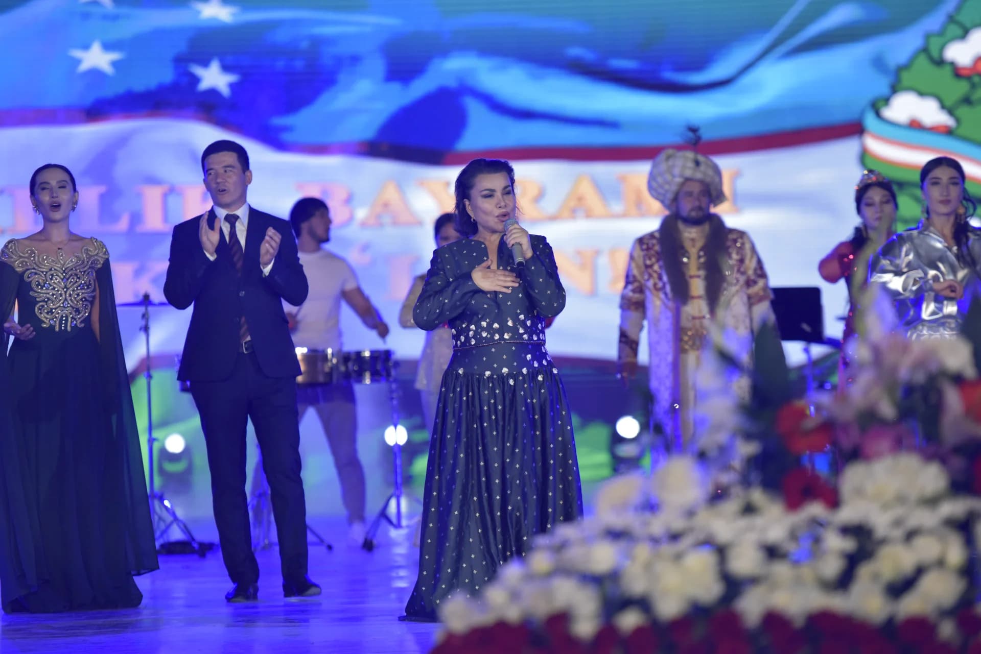 Performers singing on stage during an event