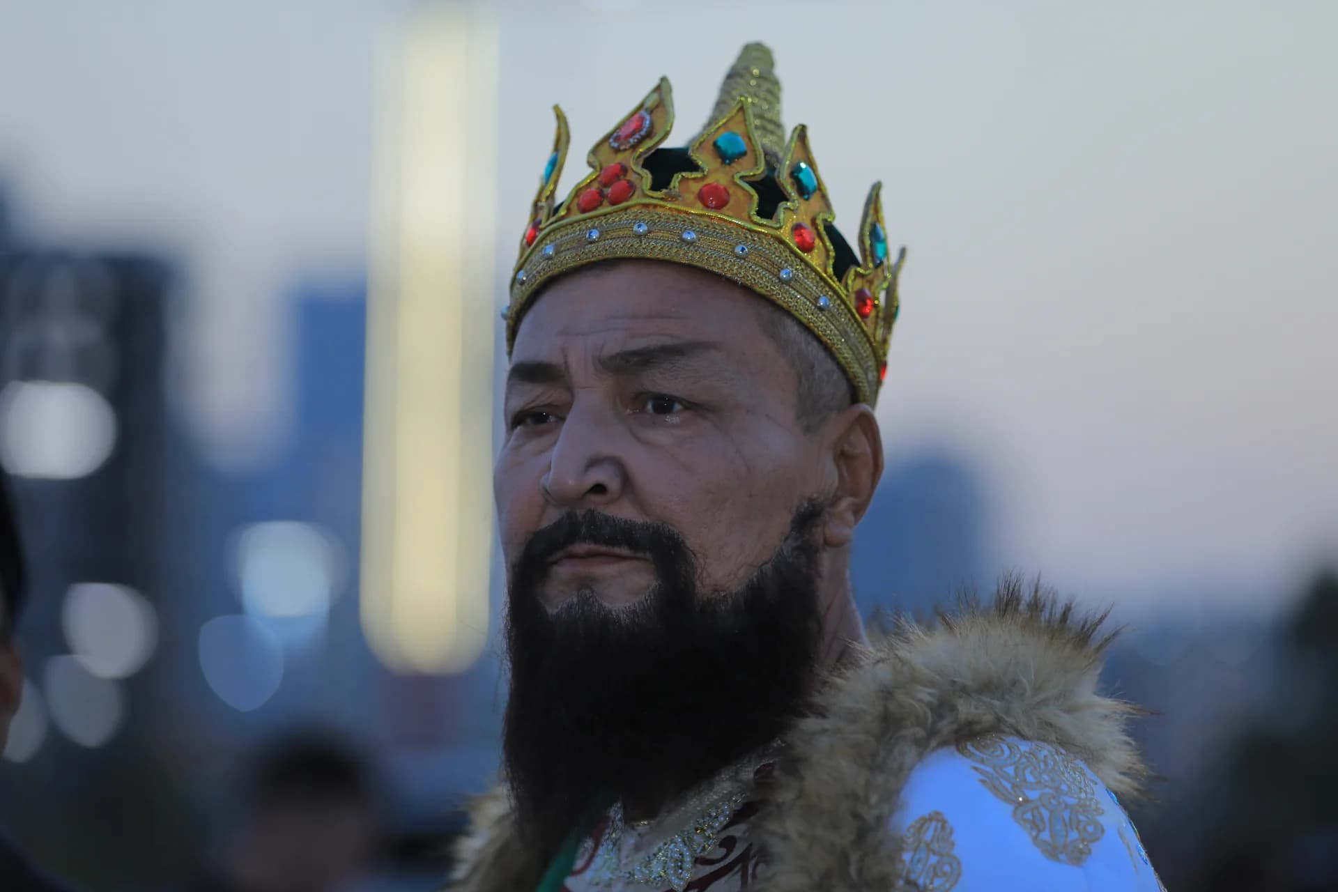 Man wearing ornate crown and historical costume