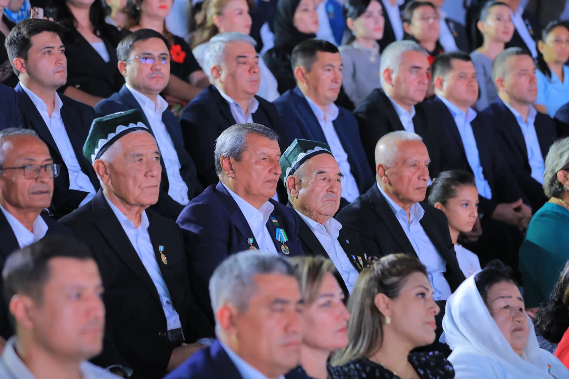 People seated in an audience indoors