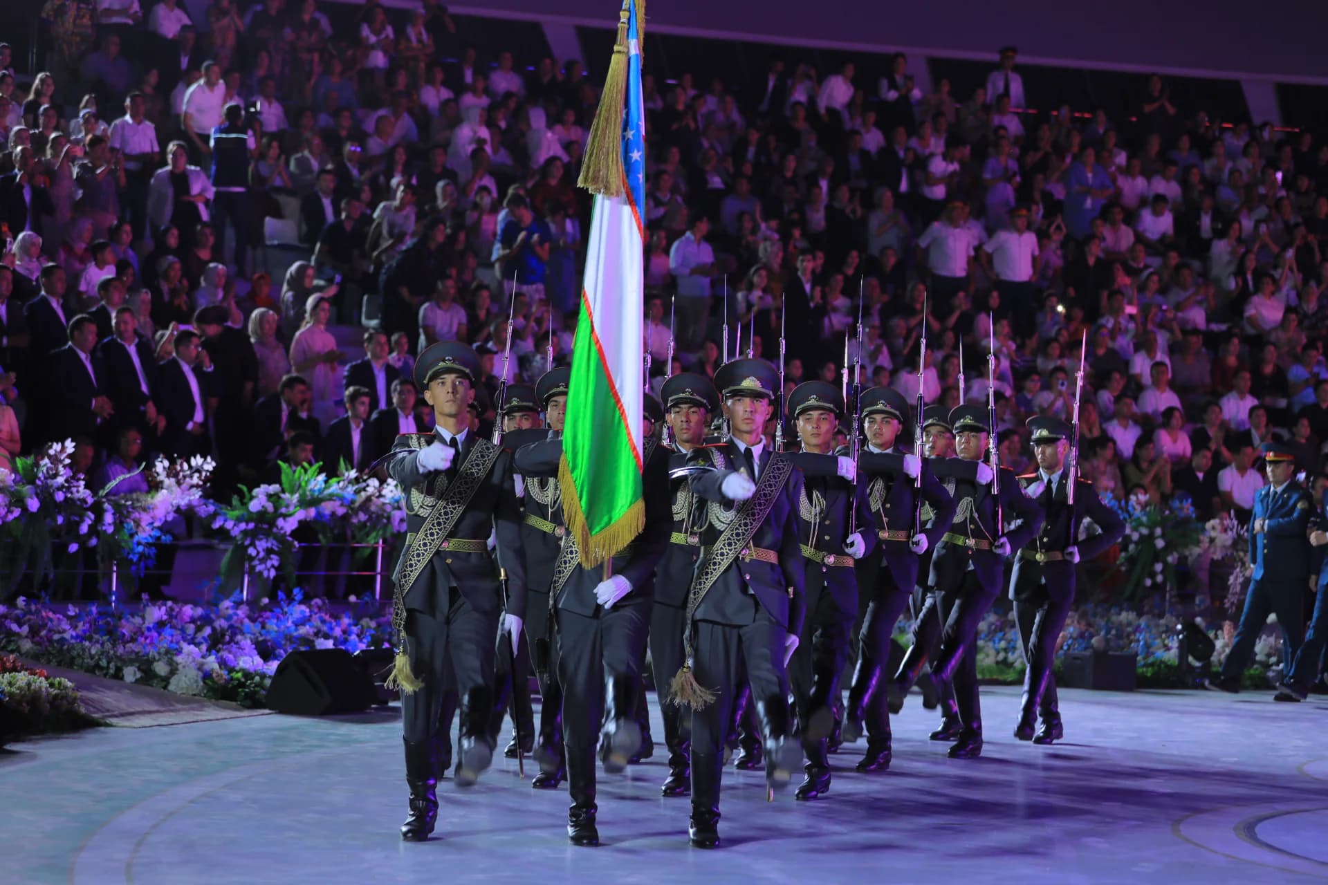 Military personnel carrying flag during ceremony