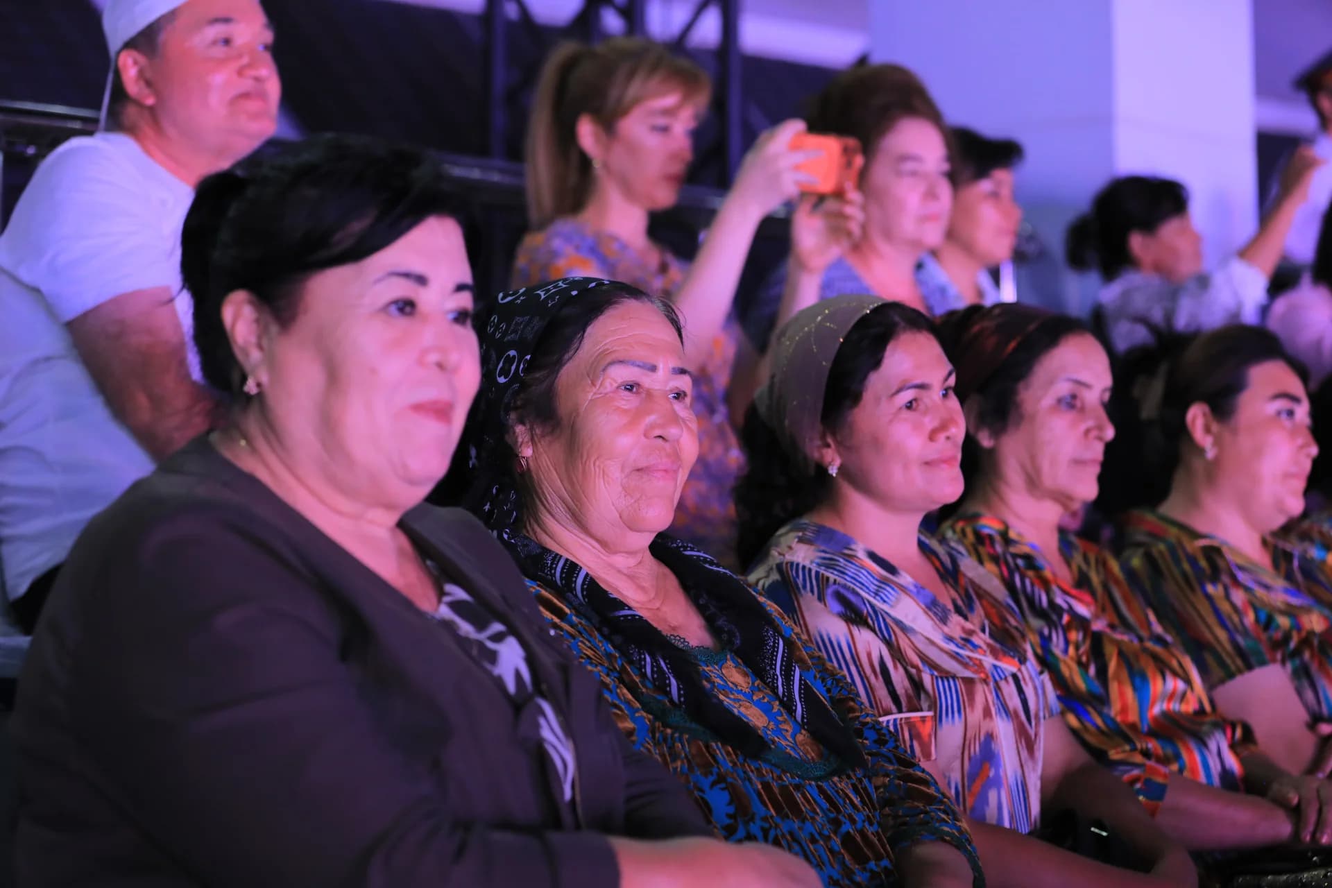 People gathered indoors watching an event