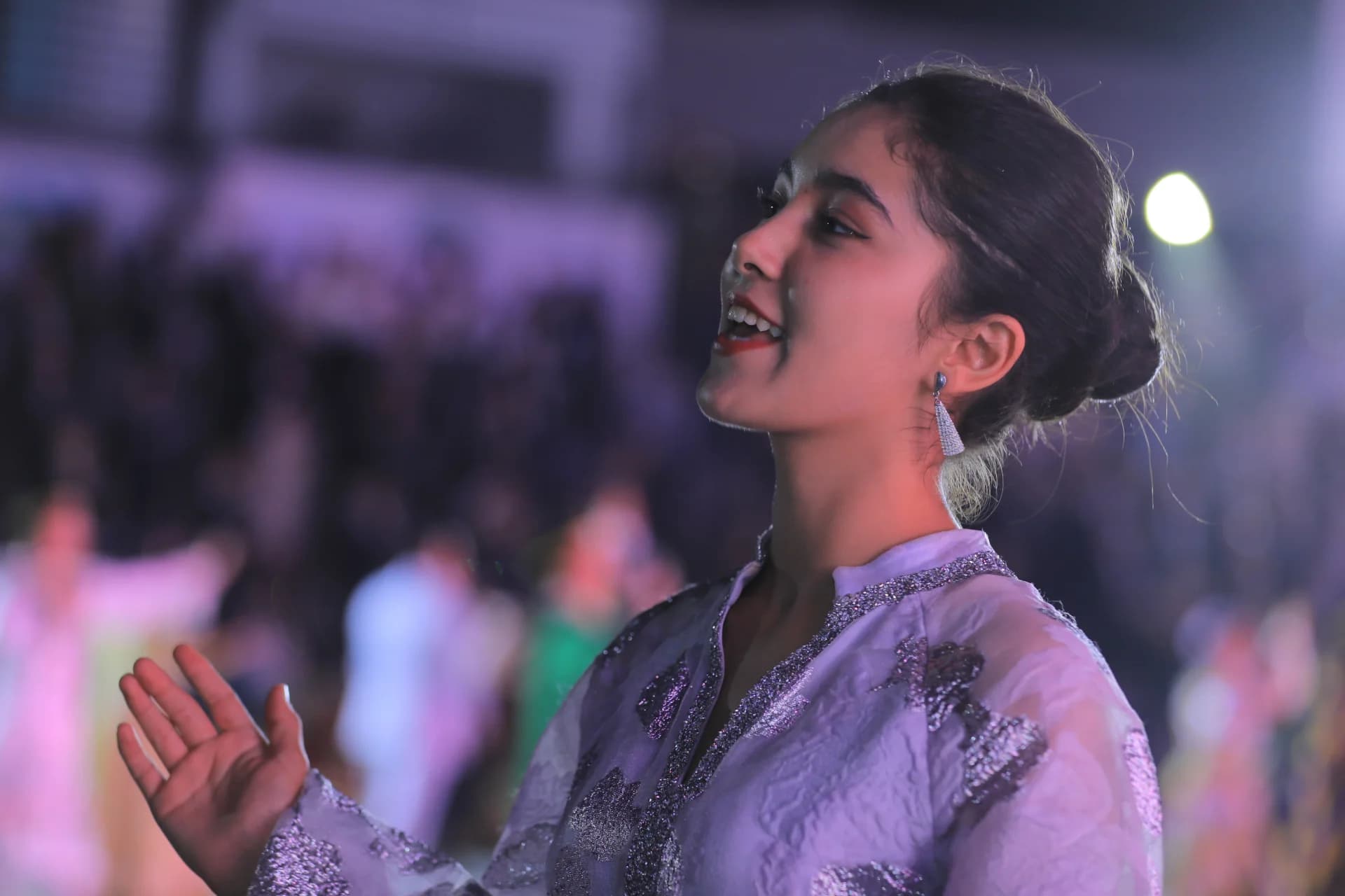 Young woman performing in light