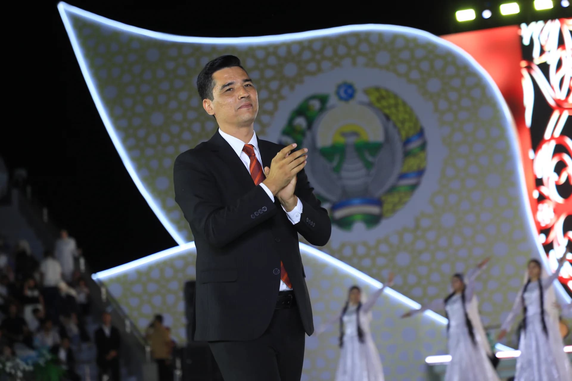 Man clapping during an event on stage