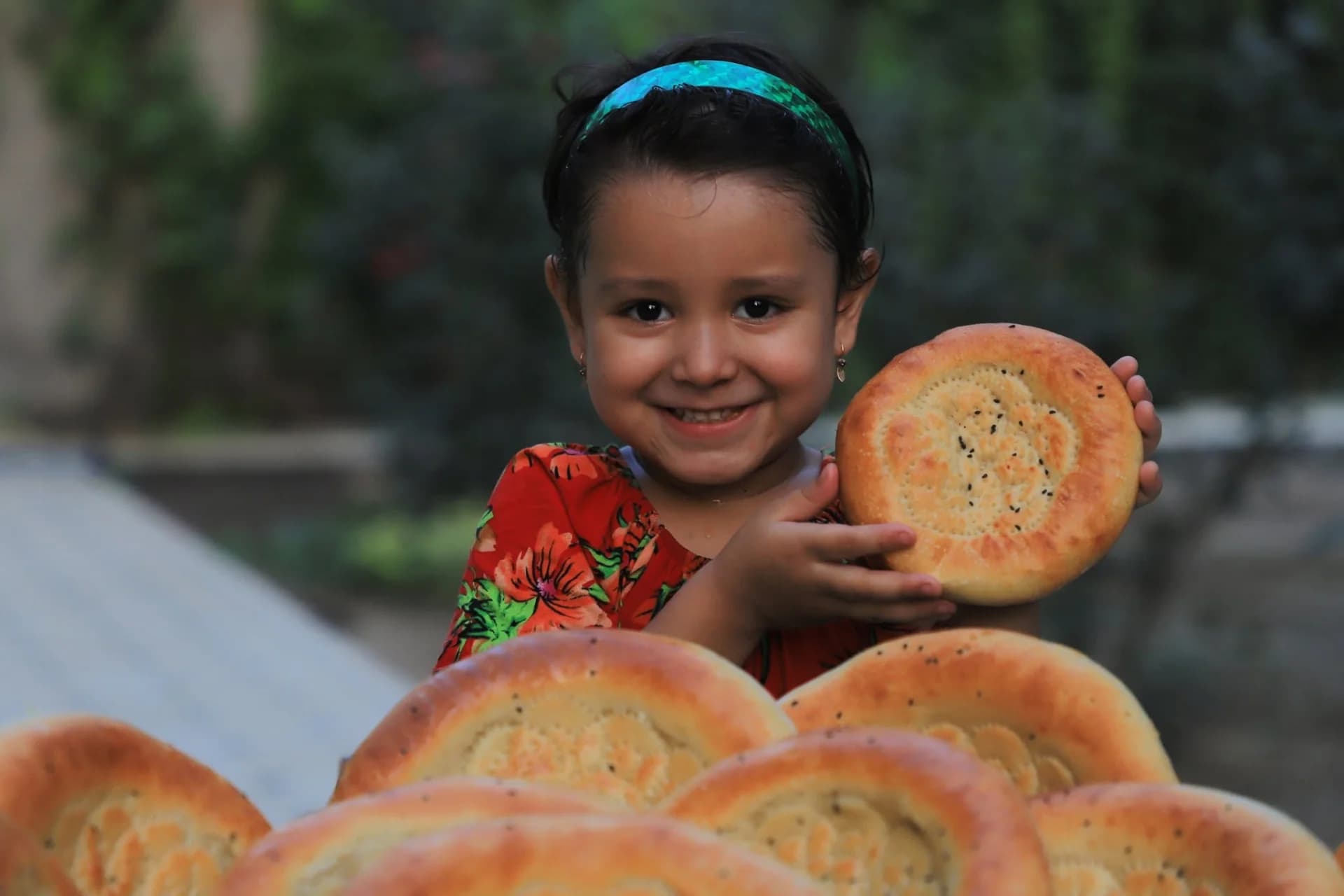 Young child holding round flatbread