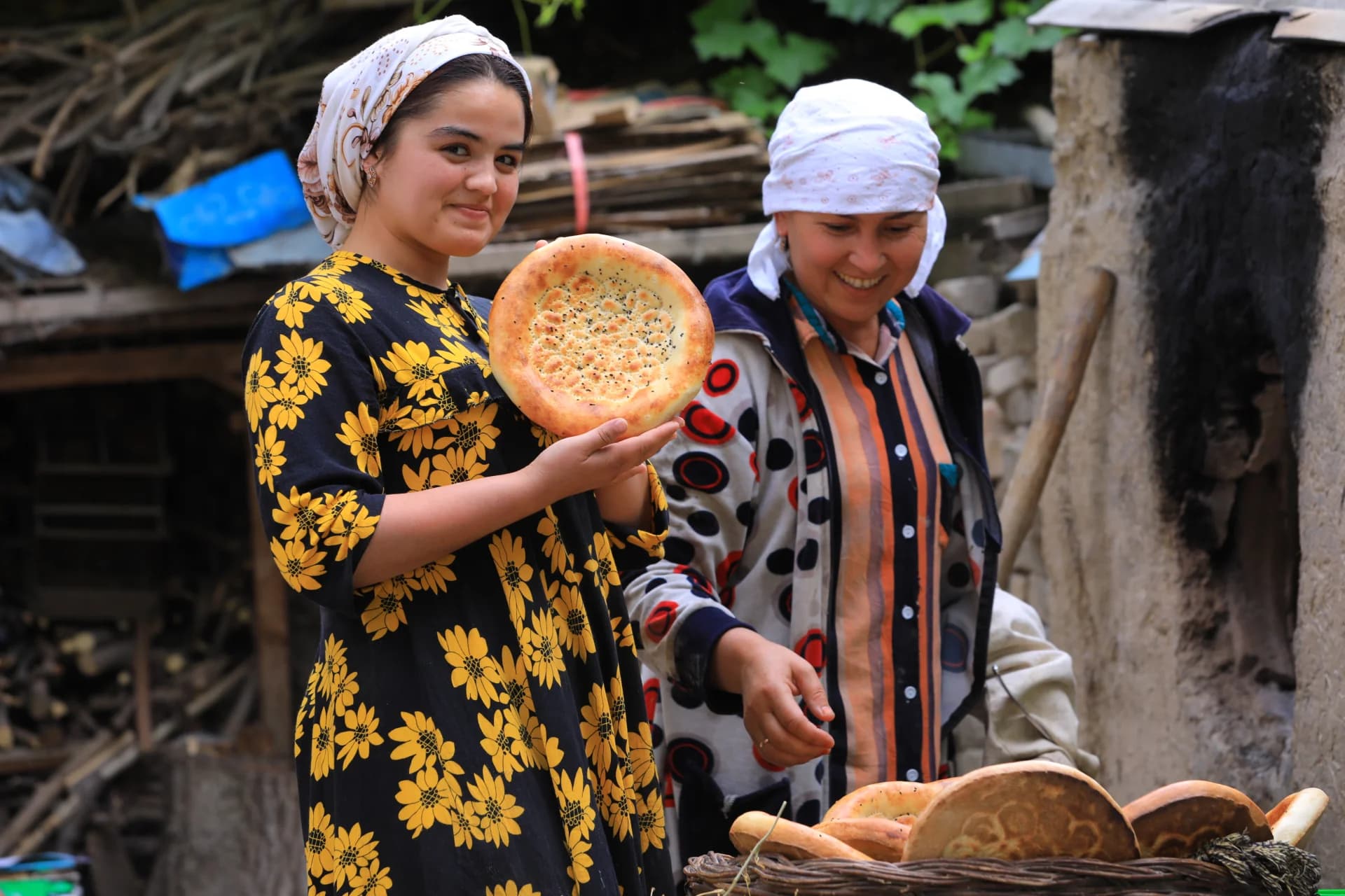 People holding traditional flatbread outdoors