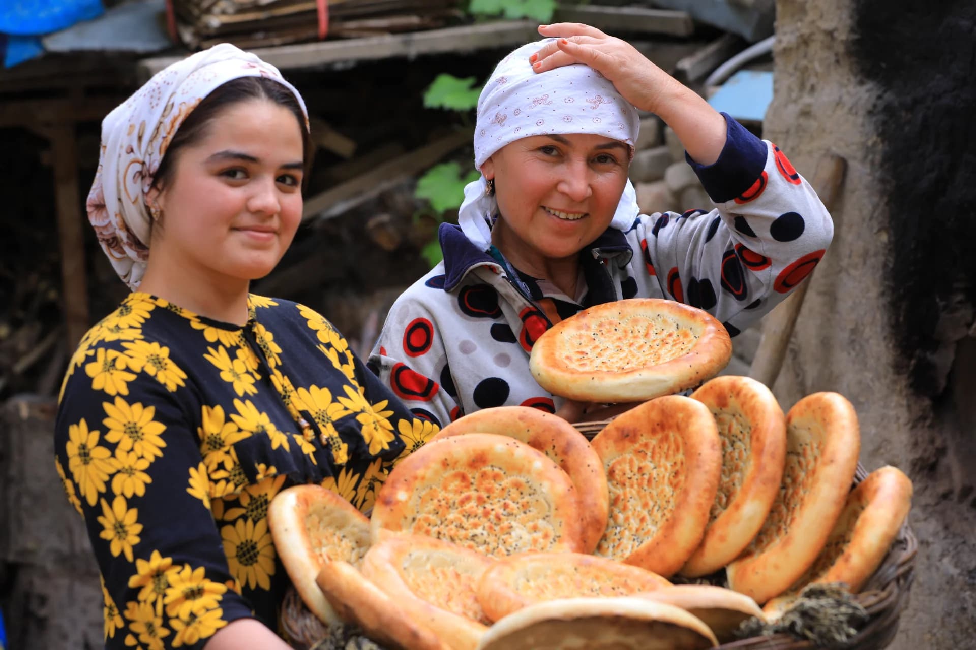 People holding freshly baked flatbreads