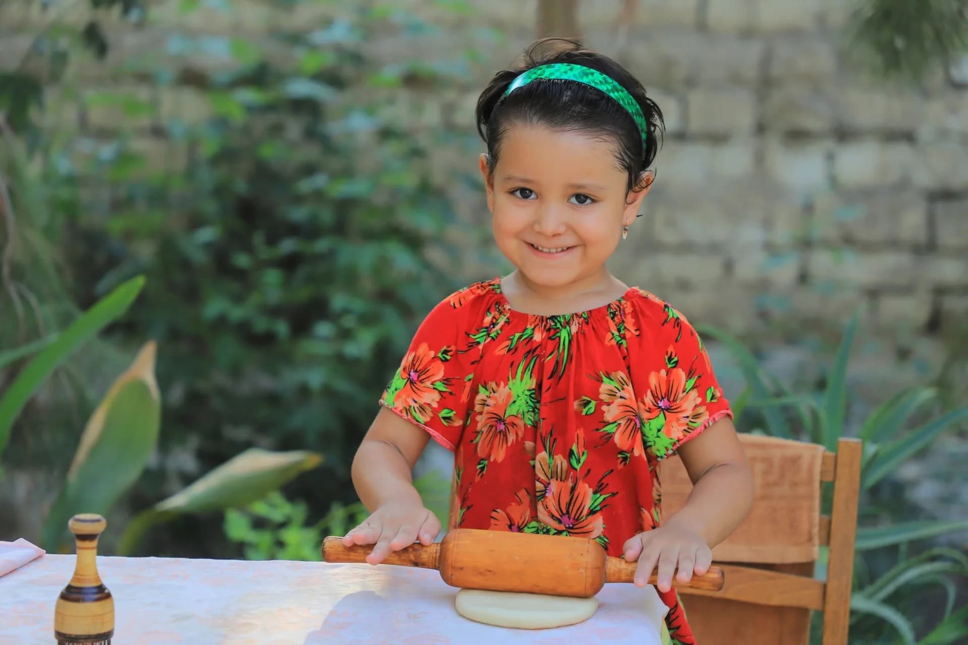 Young girl holding a rolling pin