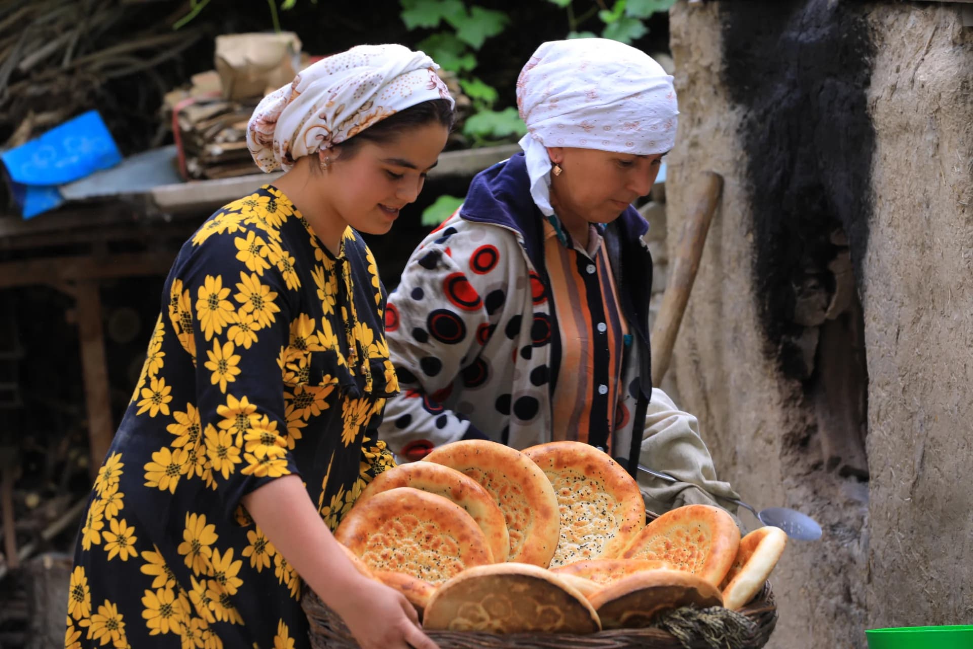Women holding a basket filled with freshly baked flatbreads