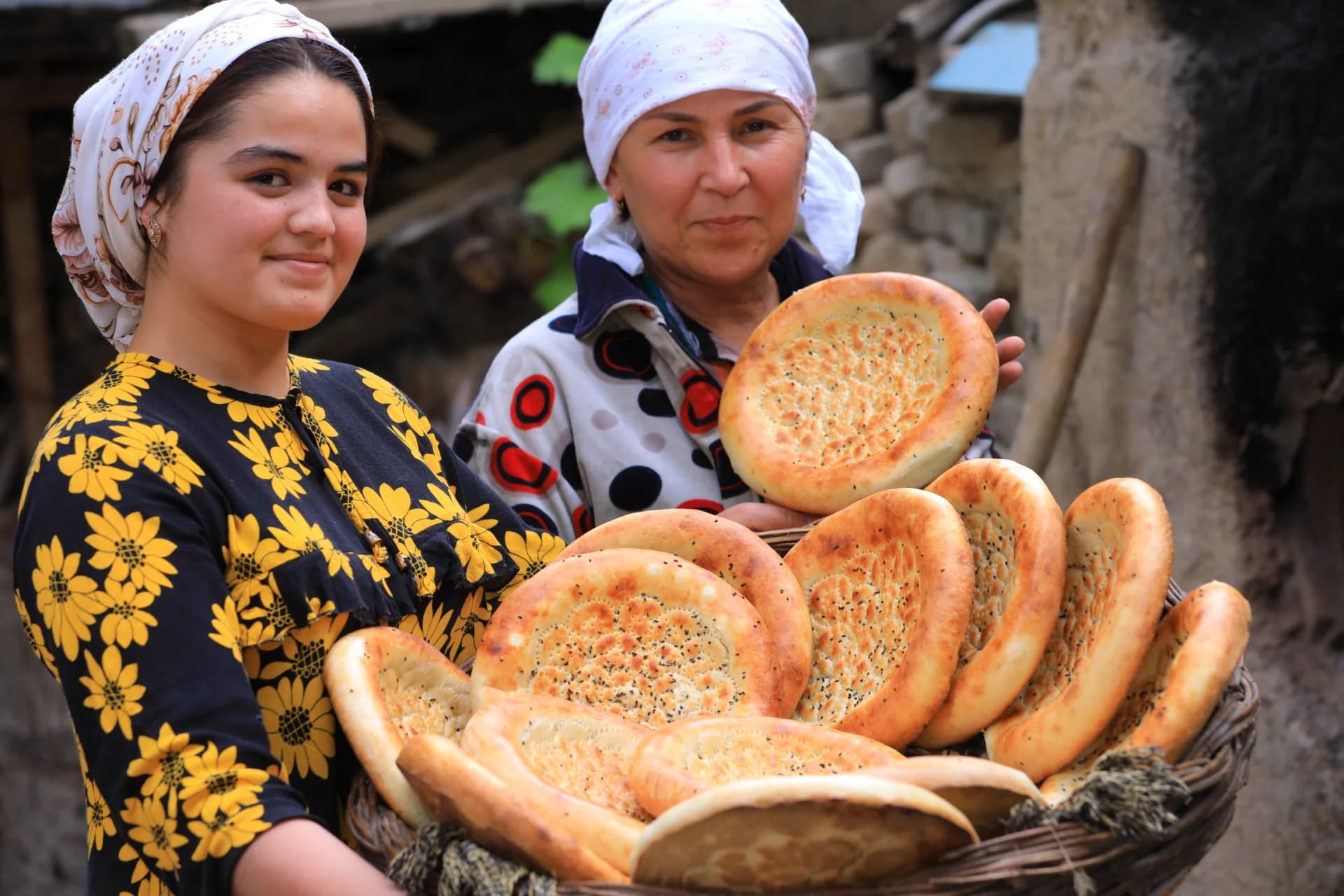 People holding freshly baked flatbreads