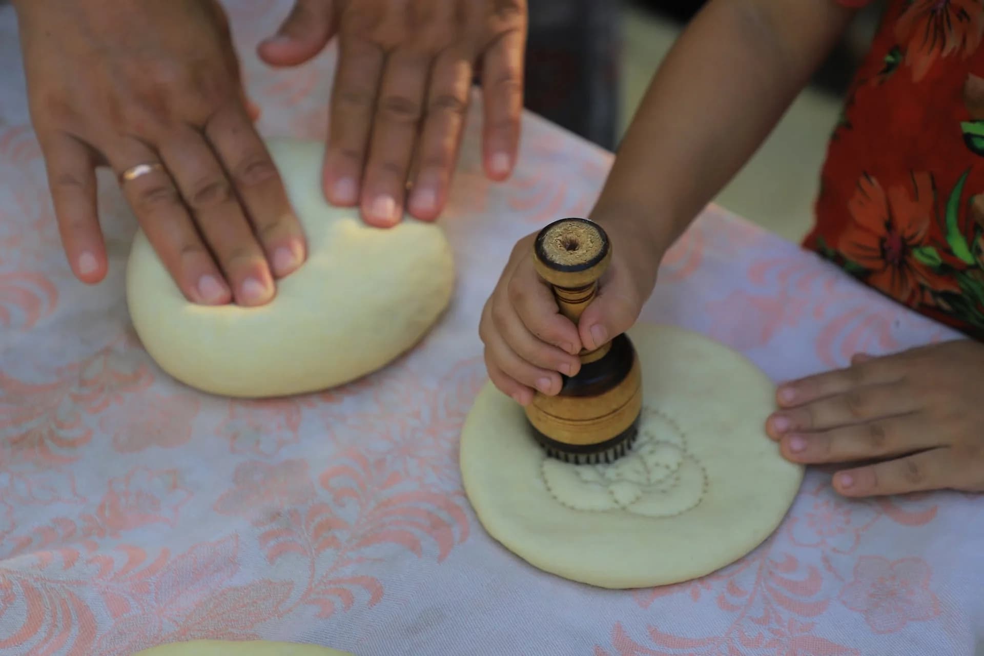 People preparing dough on a table