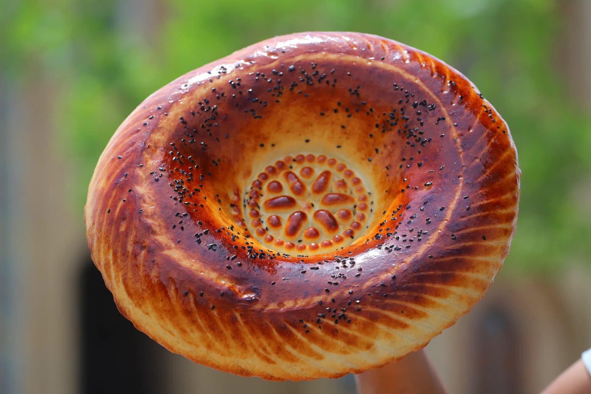 Freshly baked traditional round flatbread with dark seeds