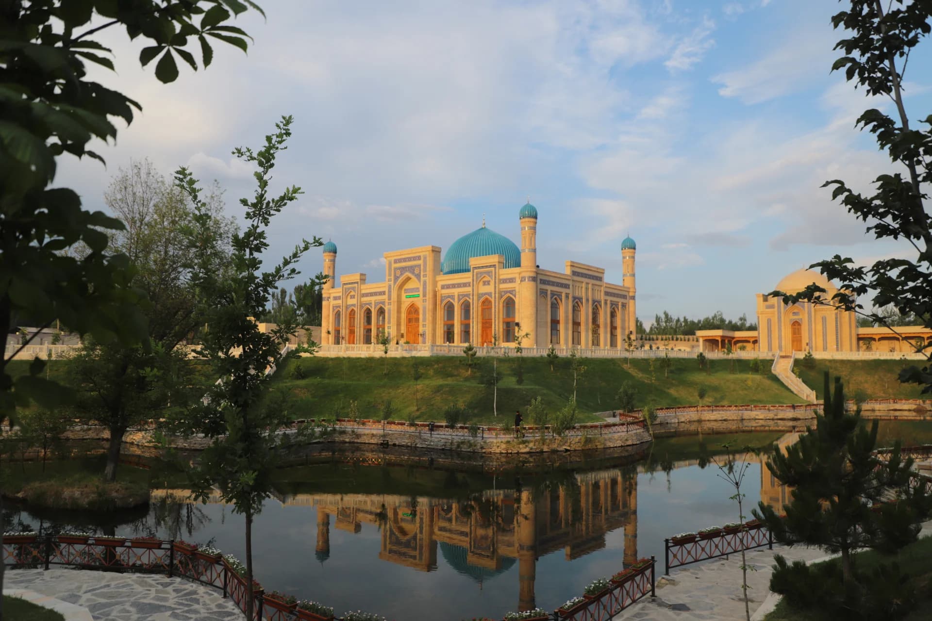 Mosque with blue domes and architectural details by water