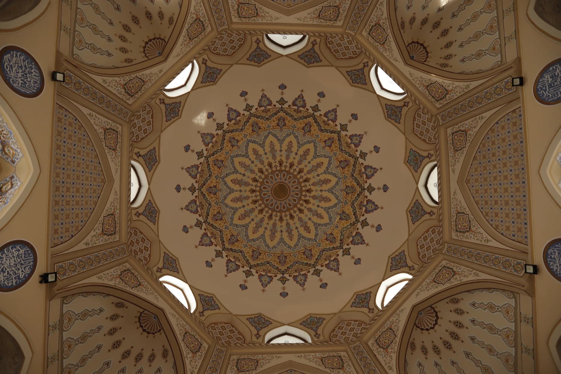 Intricate geometric patterns and central medallion on a domed ceiling
