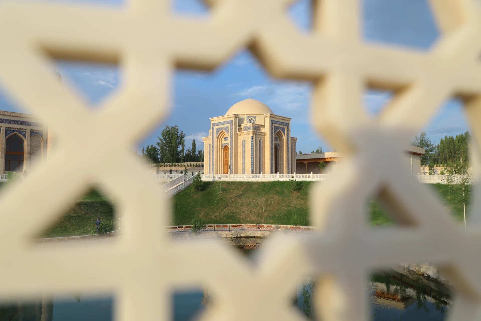 Dome structure viewed through a geometric patterned screen