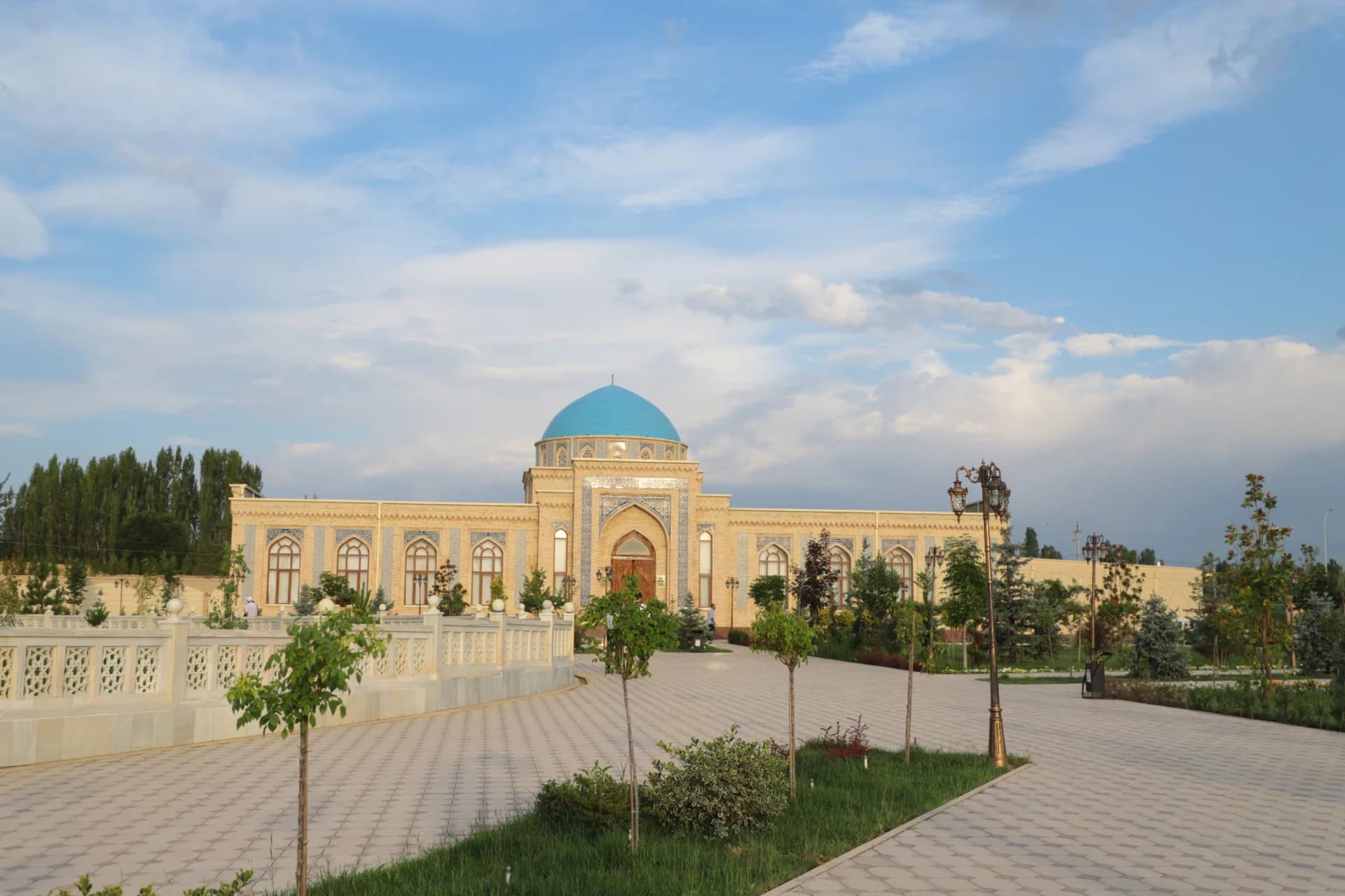 Exterior view of a mosque with a blue dome and decorative facade