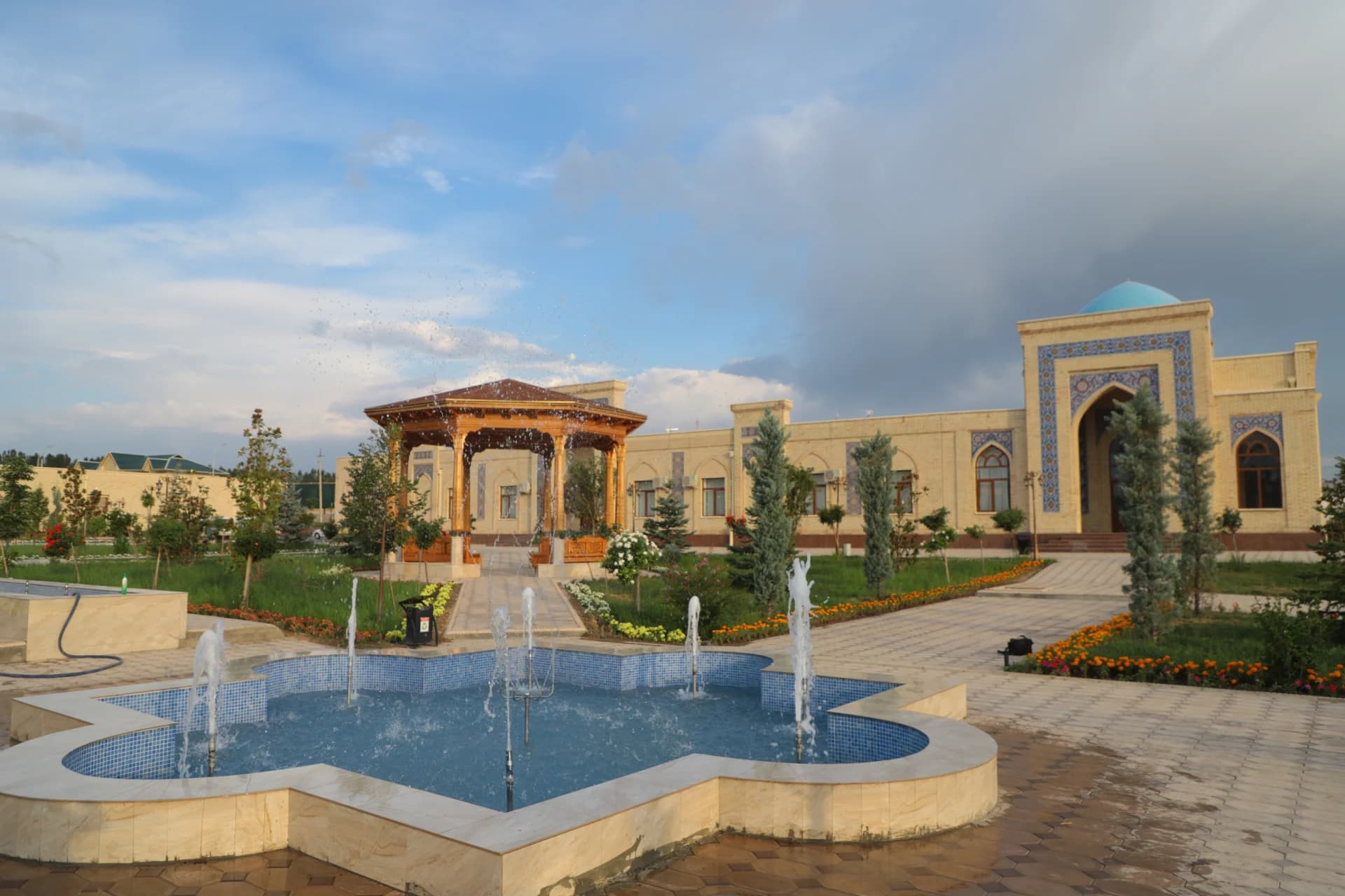 Fountain in front of a building with a blue dome