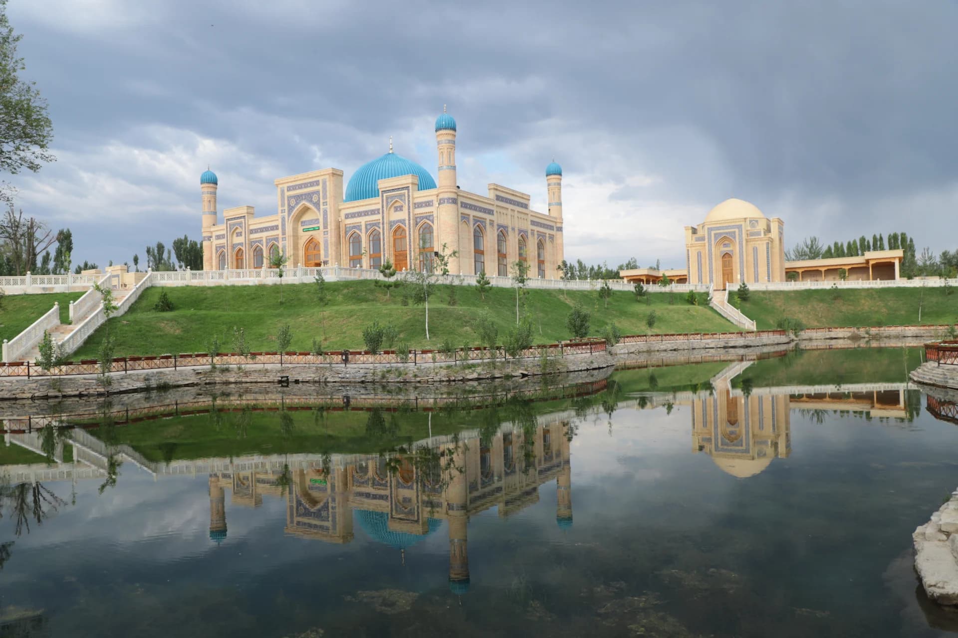 Mosque with blue domes and reflection in water