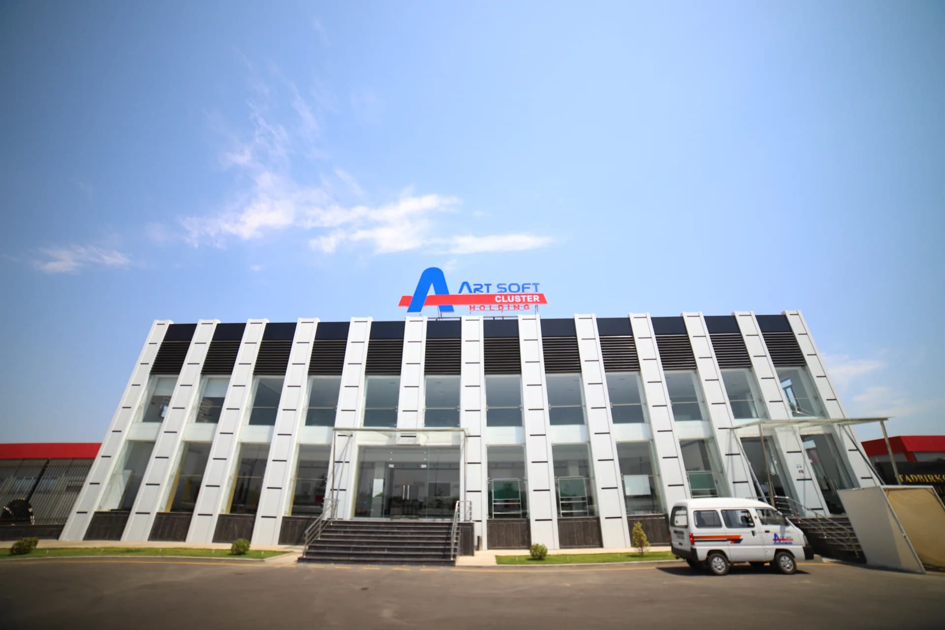 Modern commercial building exterior with large glass facade and signage