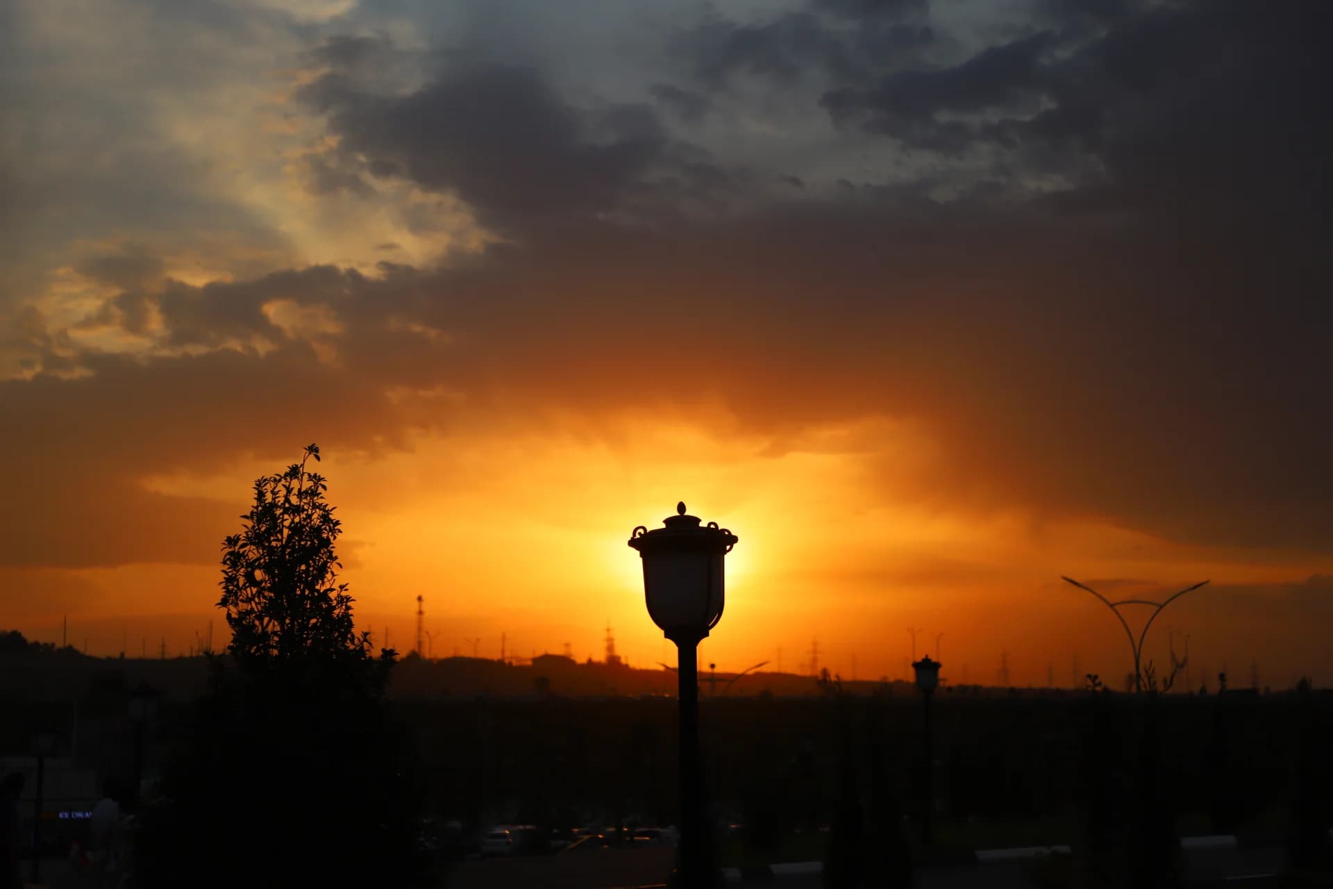 Dramatic sunset over an urban park silhouette