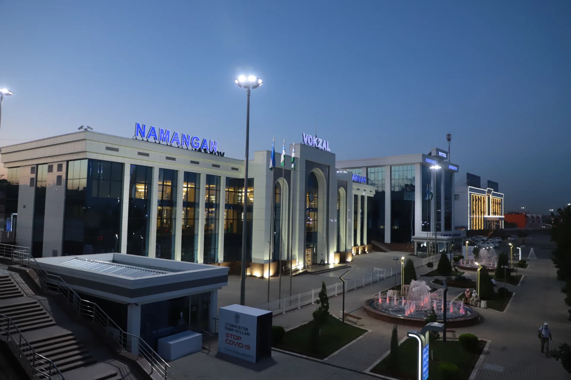 Illuminated railway station building at dusk